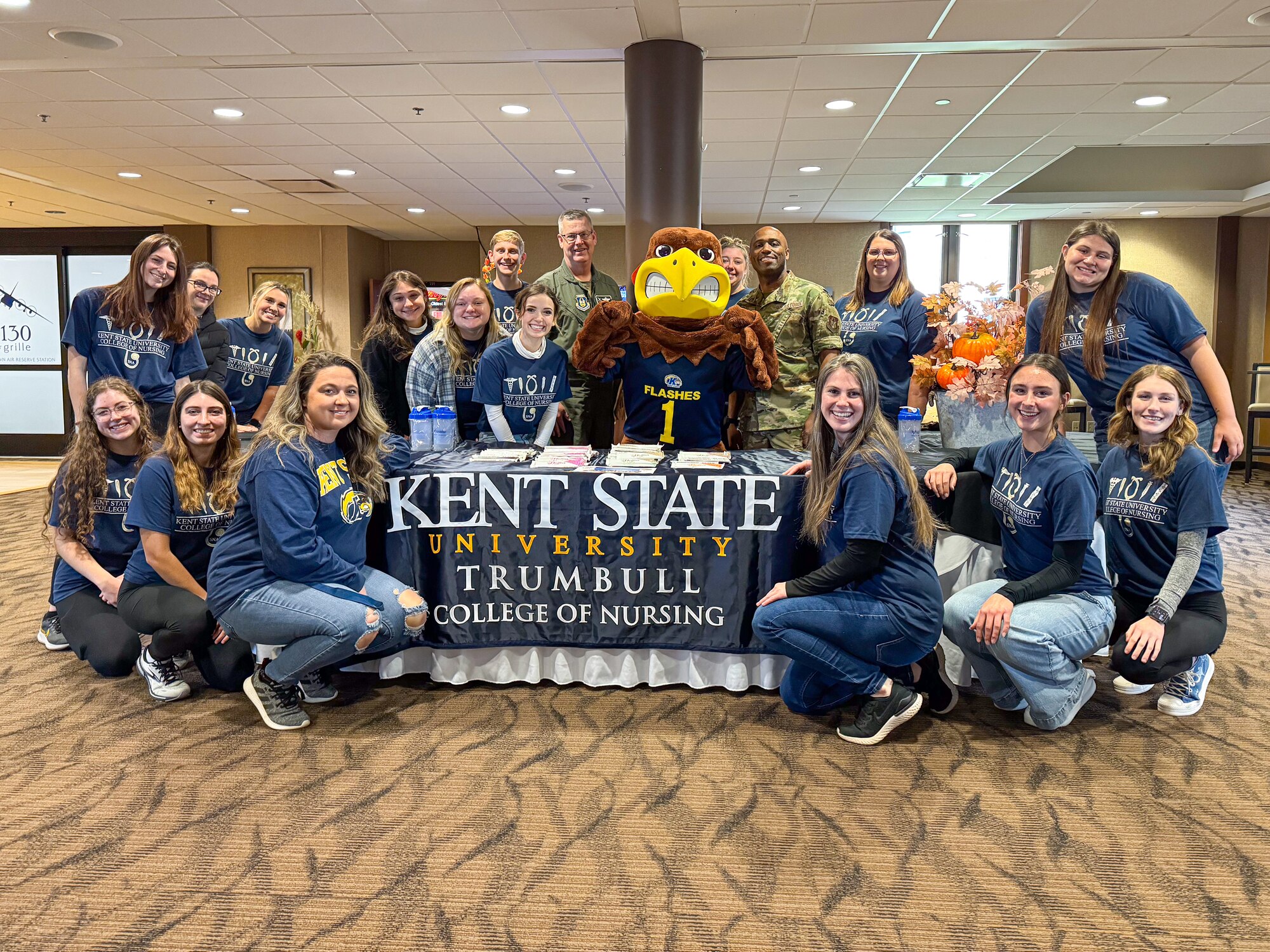 Col. Michael Maloney, 910th Airlift Wing commander, and Chief Master Sgt. Howard Dixon, 910th AW command chief, pose for a photo with nursing students from Kent State University’s Trumbull Campus at Youngstown Air Reserve Station, Ohio, Nov. 2, 2024.