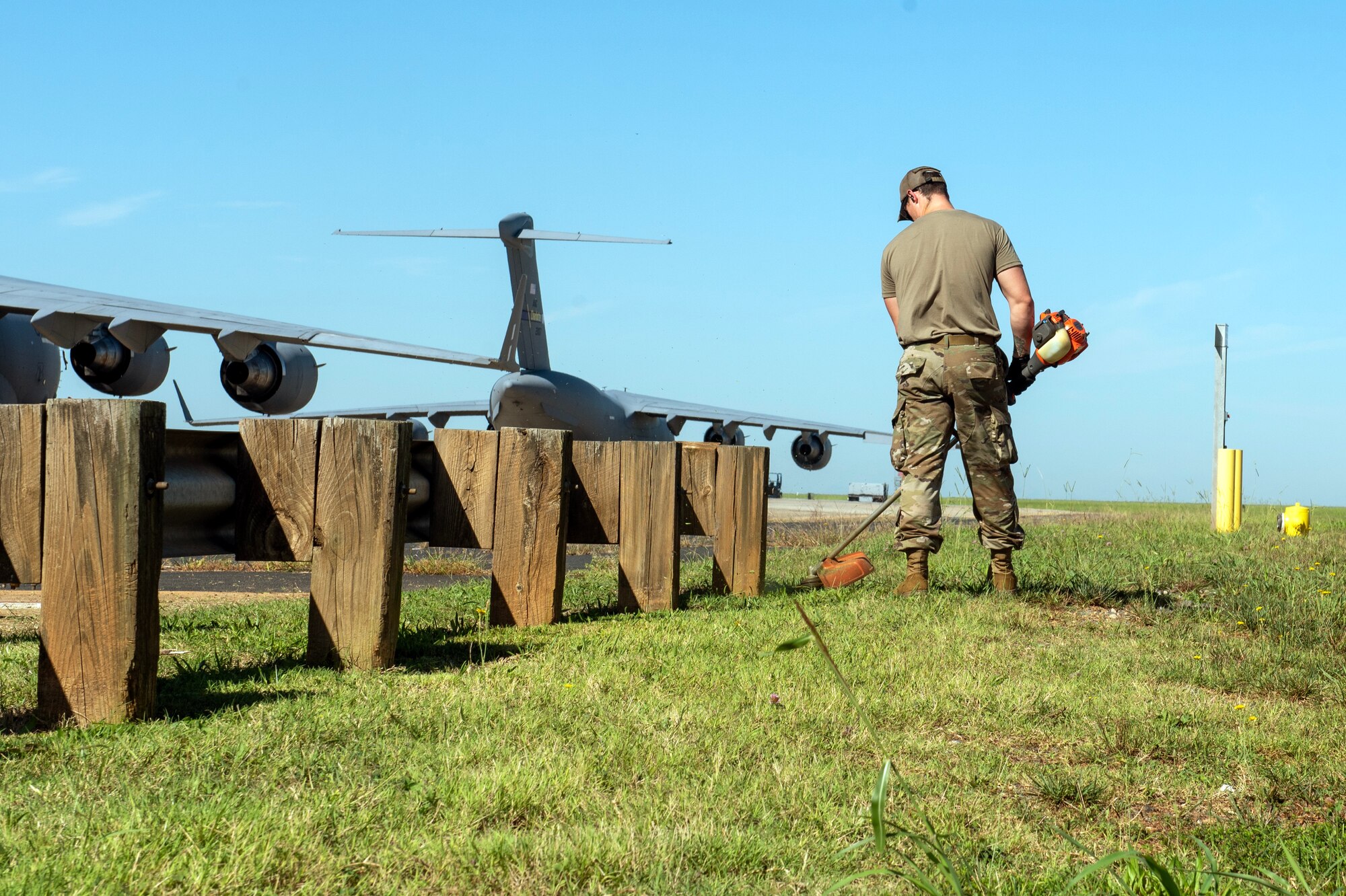 U.S. Air Force troop from the 145th Airlift Wing (145 AW) cuts grass along the flightline at the Air National Guard Base, Charlotte Douglas International Airport, Sept. 9, 2023.