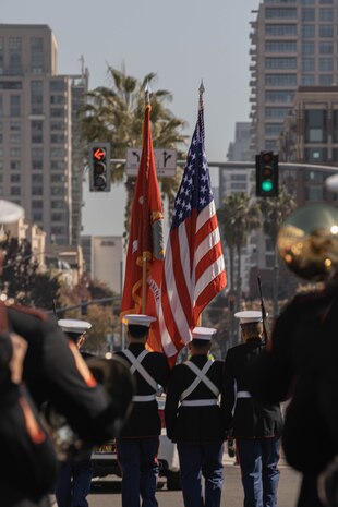 U.S. Marines with the Headquarters and Service Battalion, Marine Corps Recruit Depot San Diego’s color guard march the colors during the San Diego Veterans Day Parade in San Diego, California, Nov. 11, 2024.  The Color Guard carries the National Ensign and the Marine Corps Battle Colors at ceremonies and events. (U.S. Marine Corps photo by Cpl. Alexandra M. Earl)