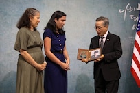 Young Ho Jung, Consul General of the Republic of Korea, presents a plaque with a picture of MIA Sgt. Frank Ayala Velasco to surviving family members during a Memorial Services for U.S. Military Members Missing in Action During the Korean War ceremony, November 10, 2024, held at Calvary Korean Baptist Church of Houston.