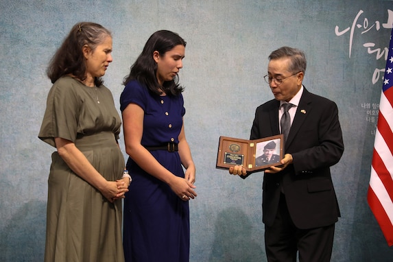 Young Ho Jung, Consul General of the Republic of Korea, presents a plaque with a picture of MIA Sgt. Frank Ayala Velasco to surviving family members during a Memorial Services for U.S. Military Members Missing in Action During the Korean War ceremony, November 10, 2024, held at Calvary Korean Baptist Church of Houston.