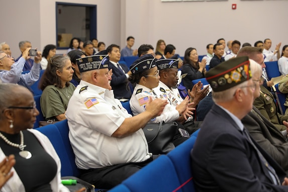 Veterans and community members in attendance applaud during a Memorial Services for U.S. Military Members Missing in Action During the Korean War ceremony, November 10, 2024, held at Calvary Korean Baptist Church of Houston.