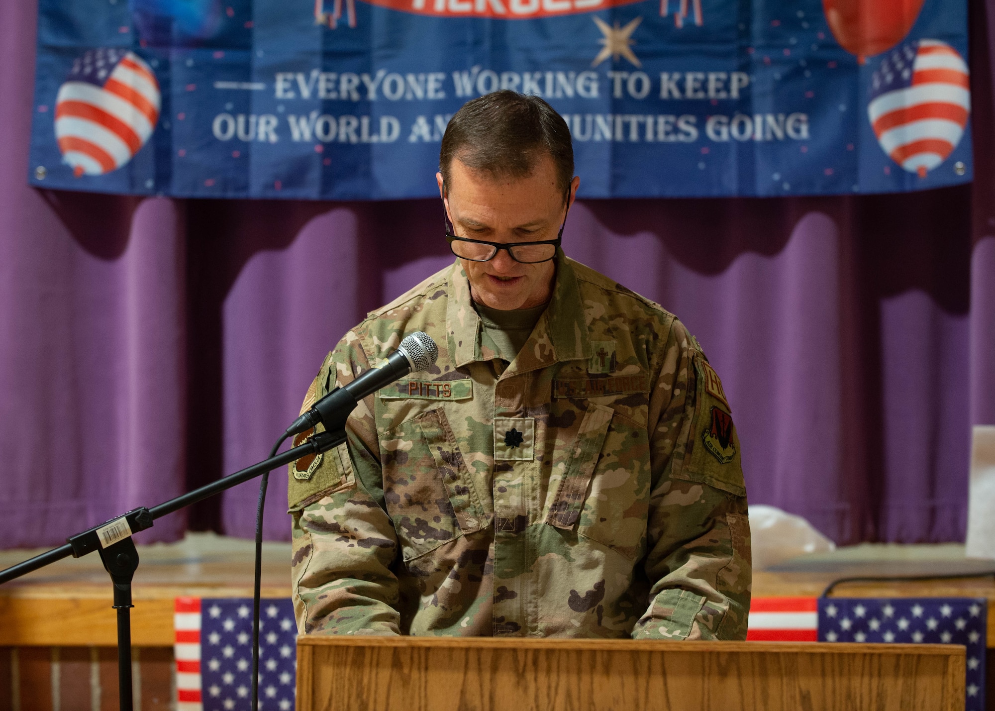 Man speaks at podium during Veterans Day parade breakfast