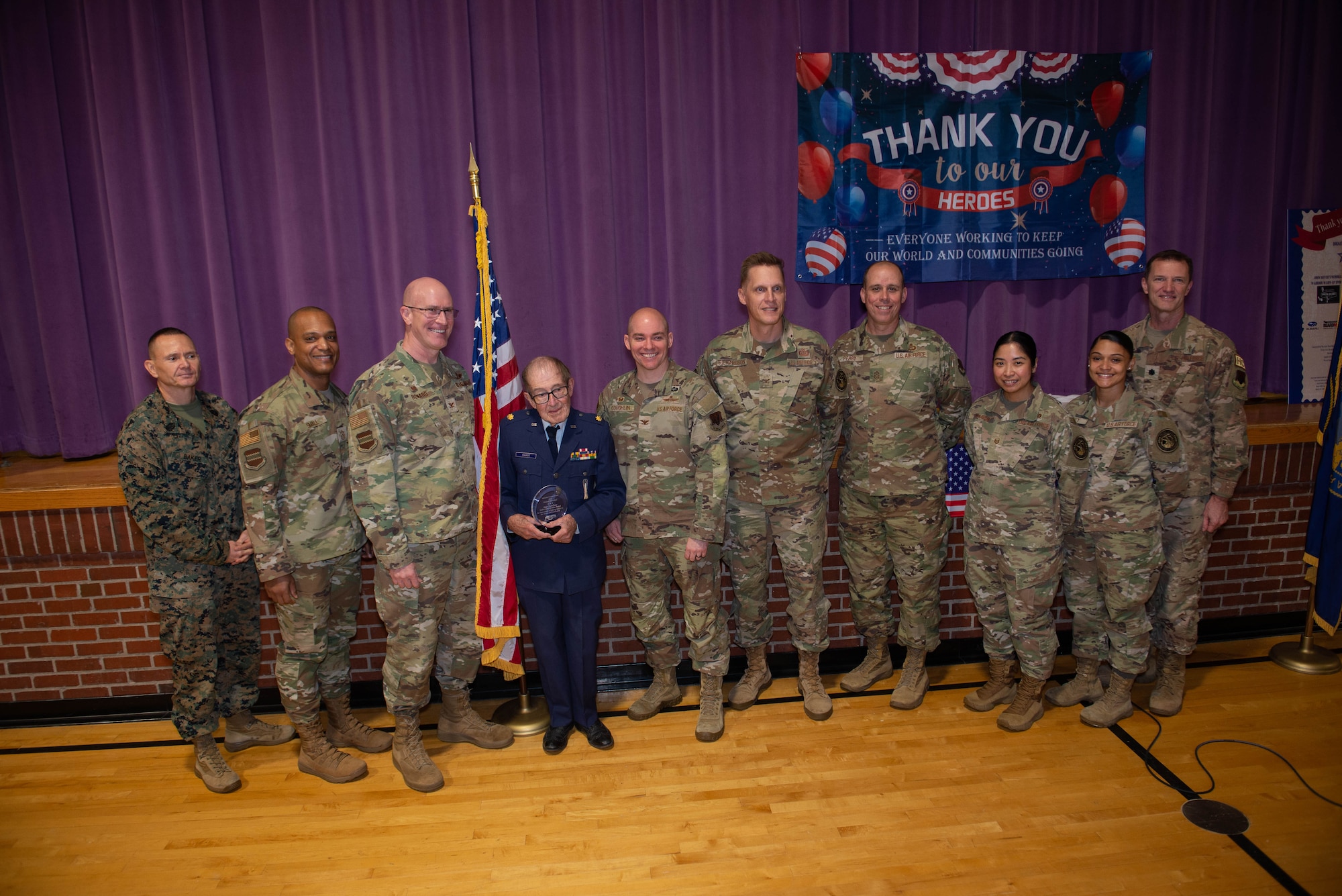 People pose for a group photo at Veterans Day parade breakfast