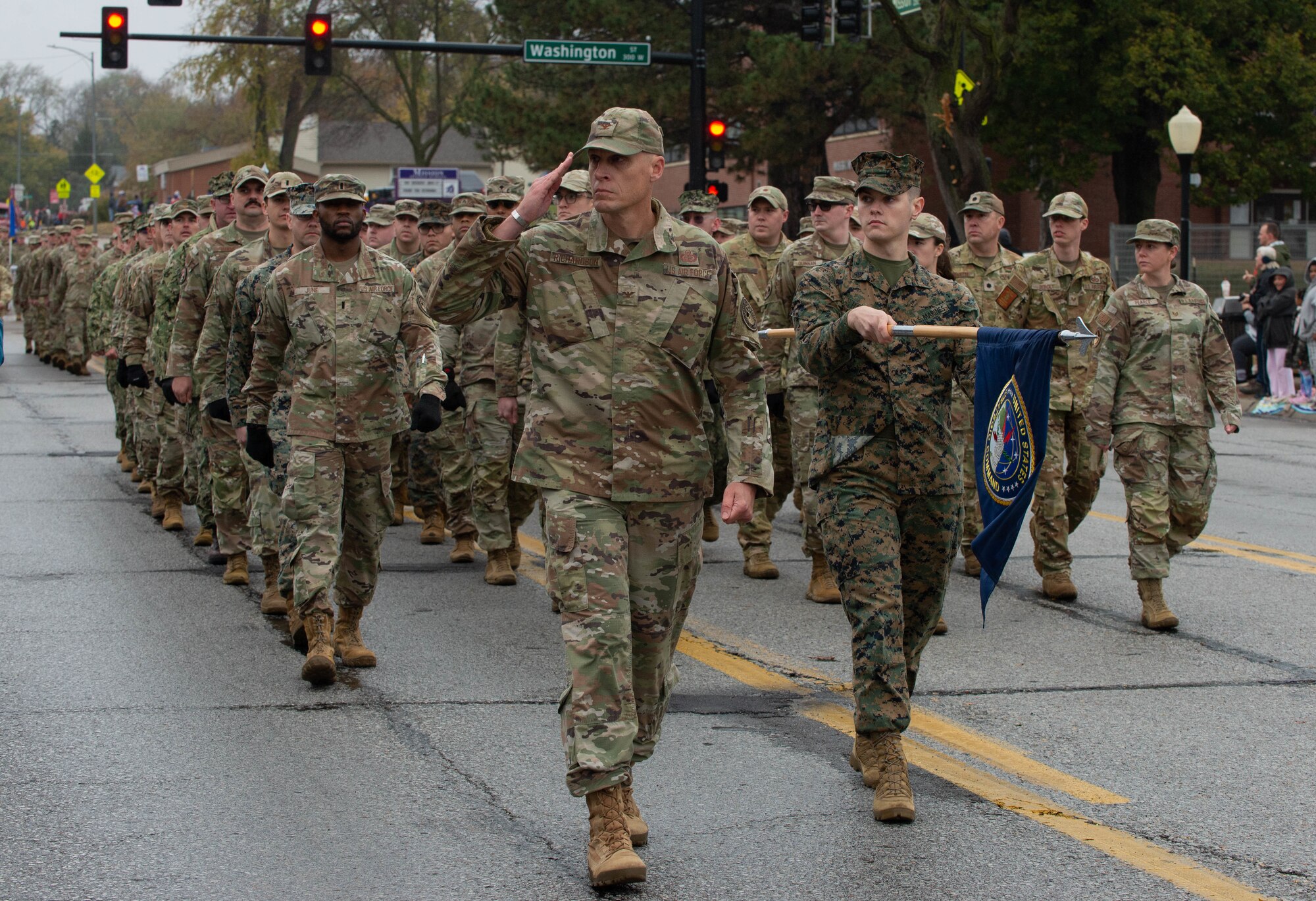 Service members march during Veterans Day parade