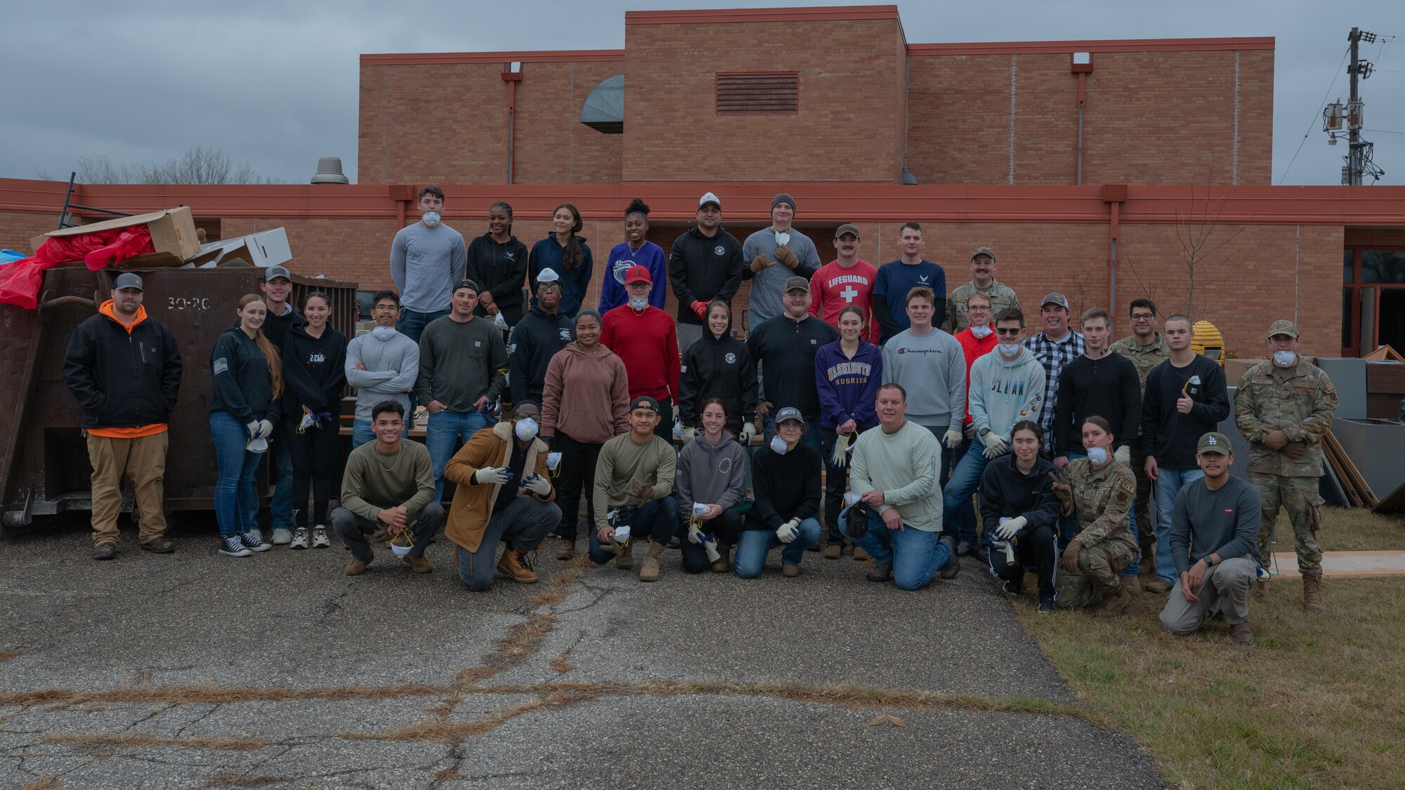 Volunteers from the 319th Reconnaissance Wing pose for a group photo during the Carl Ben Eielson School cleanup at Grand Forks Air Force Base, North Dakota, Nov. 4, 2024.