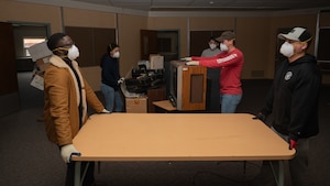 Volunteers from the 319th Reconnaissance Wing move furniture during the Carl Ben Eielson School clean-up at Grand Forks Air Force Base, North Dakota, Nov. 4, 2024.