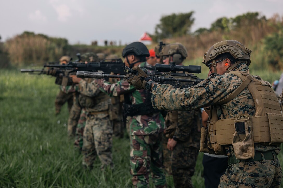 U.S. Marines with 1st Battalion, 7th Marine Regiment, attached to Marine Rotational Force-Southeast Asia, and Indonesian marines 4th Marine Infantry Battalion, Pasmar 1, conduct live-fire table five combat marksmanship program training during Keris Marine Exercise 2023 at Piabung Training Area in Sukabumi, West Java, Indonesia, Dec. 7, 2023. Keris MAREX is a bilateral exercise led by the U.S. Marine Corps and the Indonesian Marine Corps, or Korps Marinir, to promote military interoperability and maritime domain awareness capabilities, strengthen relationships, and expand military capabilities among participating forces in the advancement of a Free and Open Indo-Pacific. MRF-SEA is a Marine Corps Forces Pacific operational model that involves exchanges with subject matter experts, promotes security goals with Allies and Partners, and positions I MEF forces west of the International Date Line. (U.S. Marine Corps photo by Sgt. Shaina Jupiter)