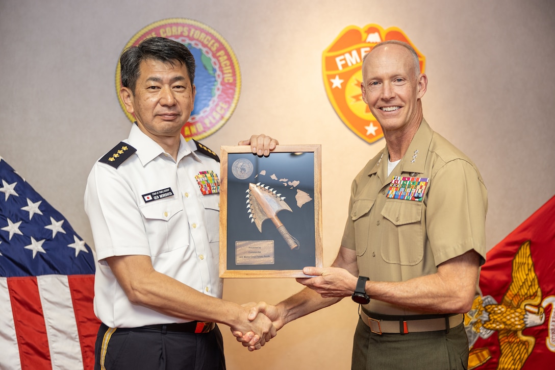 Japan Ground Self Defense Force Gen. Morishita Yasunori, left, chief of staff, Ground Staff Office, JGSDF, and U.S. Marine Corps Lt. Gen. James F. Glynn, commander, U.S. Marine Corps Forces, Pacific, exchange gifts during a key leader engagement on Camp H.M. Smith, Hawaii, Nov. 5, 2024. Senior MARFORPAC leaders regularly host distinguished visitors from all over the world to discuss mutual interests, foster collaboration, and share experiences among Allies and partners. (U.S. Marine Corps photo by Lance Cpl. Blake Gonter)