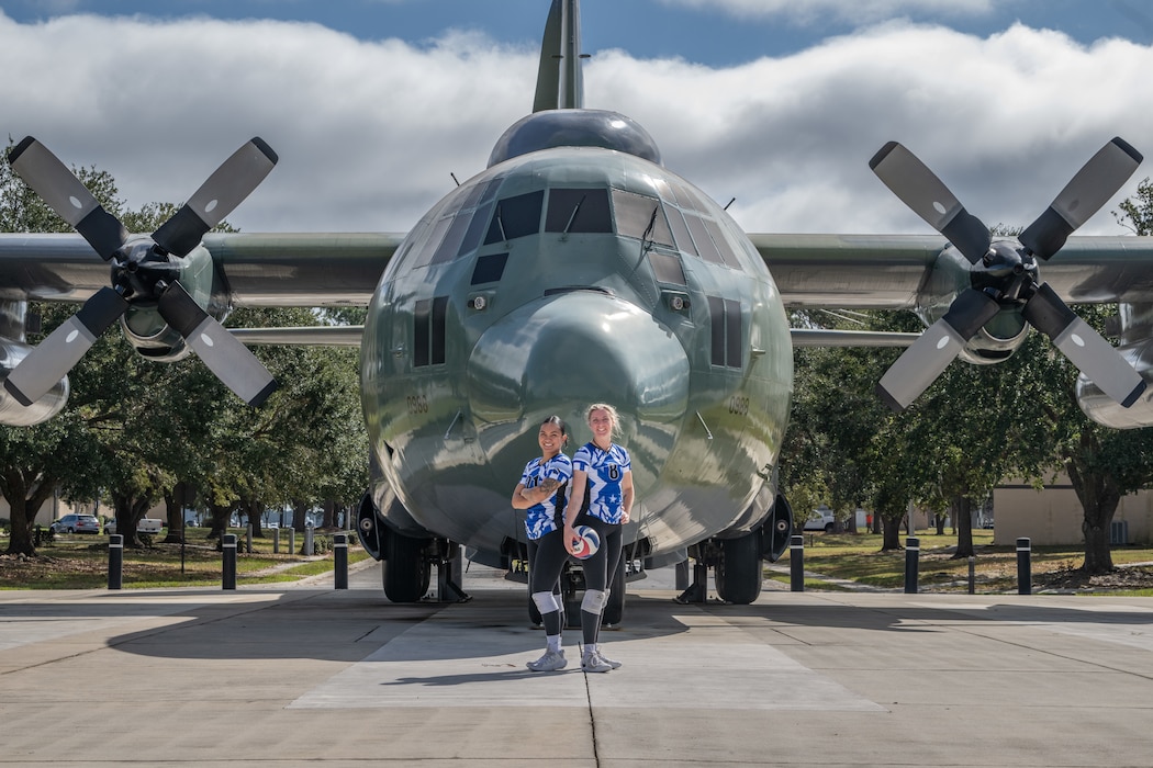 People standing in front of plane display