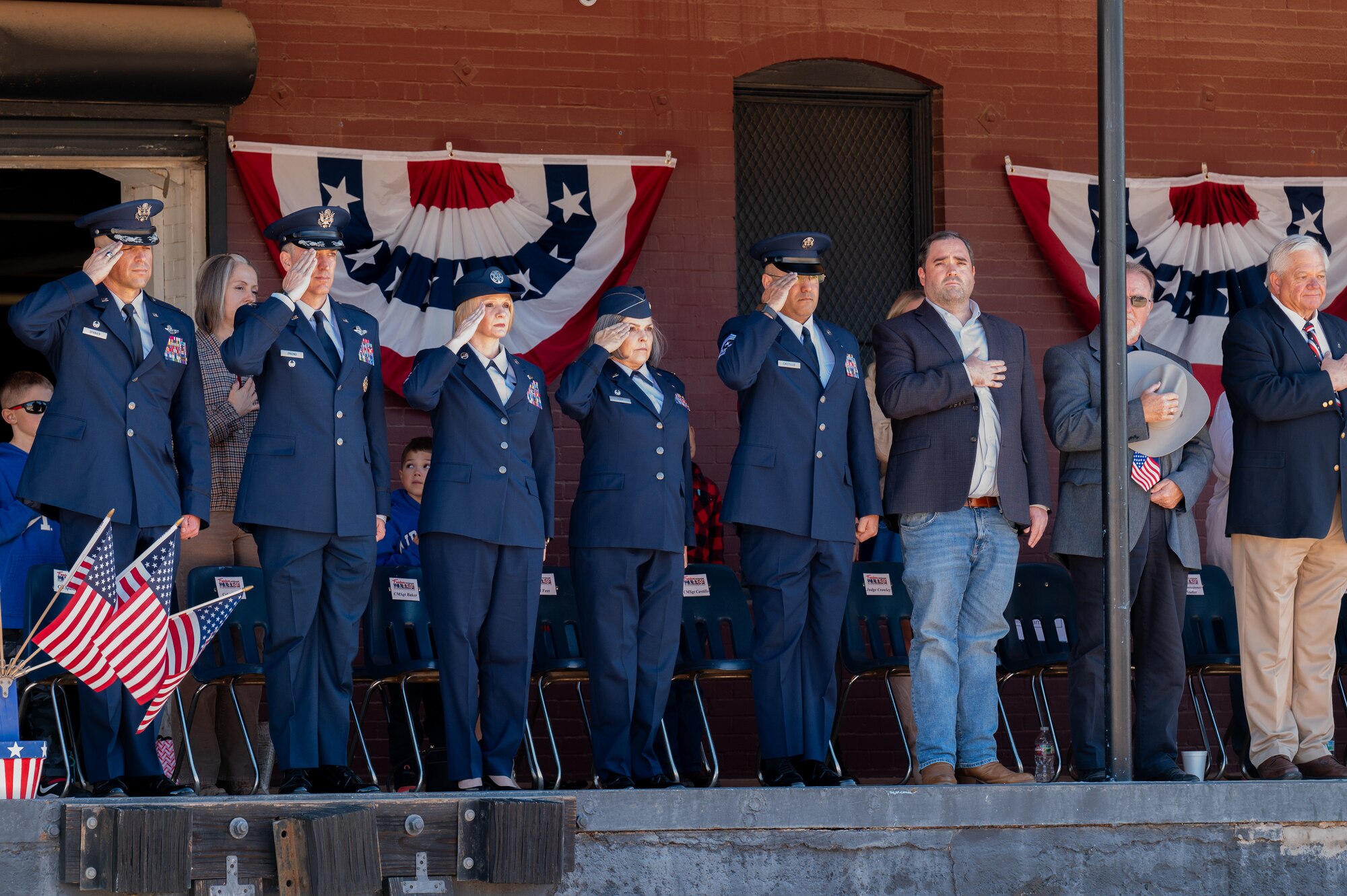 Dyess leadership salute during the national anthem in Abilene, Texas, Nov. 9, 2024. Airmen from Dyess Air Force Base, Texas participated in the Veteran’s Day parade to recognize those who served in the U.S. armed forces. (U.S. Air Force photo by Senior Airman Alondra Cristobal Hernandez)
