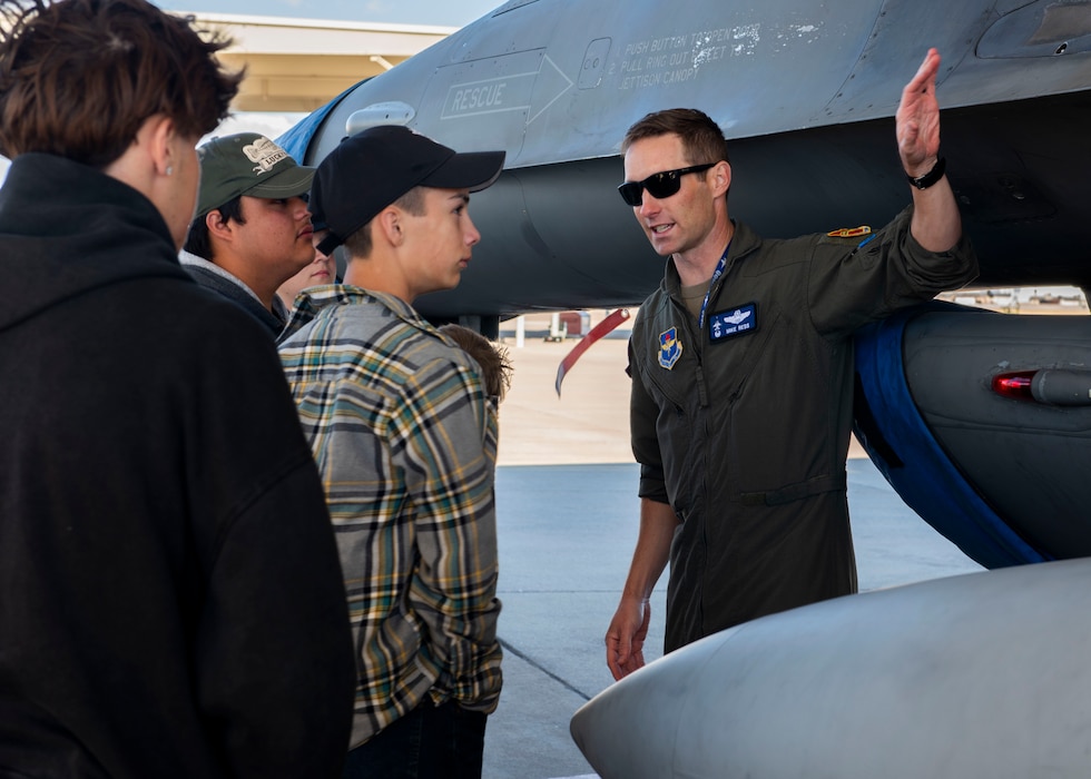 U.S. Air Force Lt. Col. Michael Ress (right), 309th Fighter Squadron commander, teaches a group of homeschooled students about the U.S. Air Force F-16 Fighting Falcon aircraft, Nov. 7, 2024, at Luke Air Force Base, Arizona.