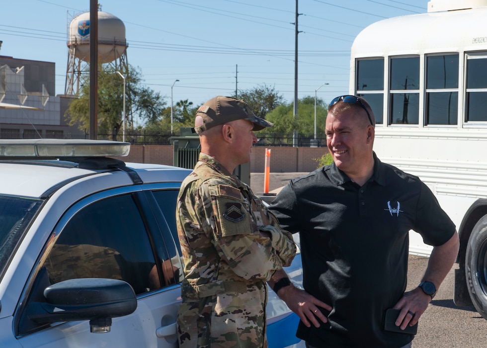 U.S. Air Force Brig Gen. David Berkland (left), 56th Fighter Wing commander, speaks to retired Maj. Gen. Brook Leonard (right), prior 56th Fighter Wing commander (2016-2018), Nov. 7, 2024, at Luke Air Force Base, Arizona.