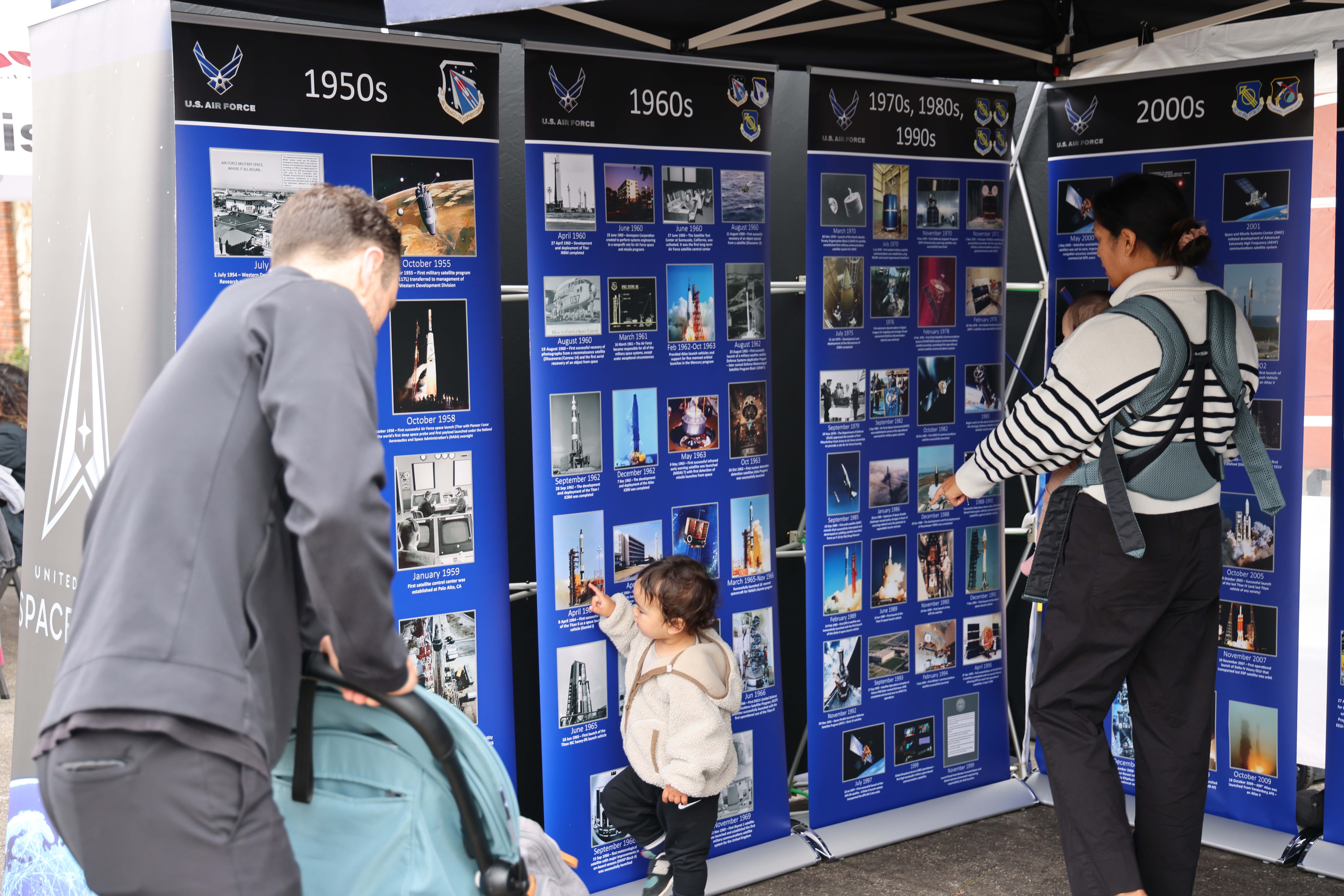 Community members gather around to view a timeline of the United States Space Force history at the Main Street Fair on Sept. 28,2024, in El Segundo, Calif. (U.S. Space Force photo by Edgar Nava).