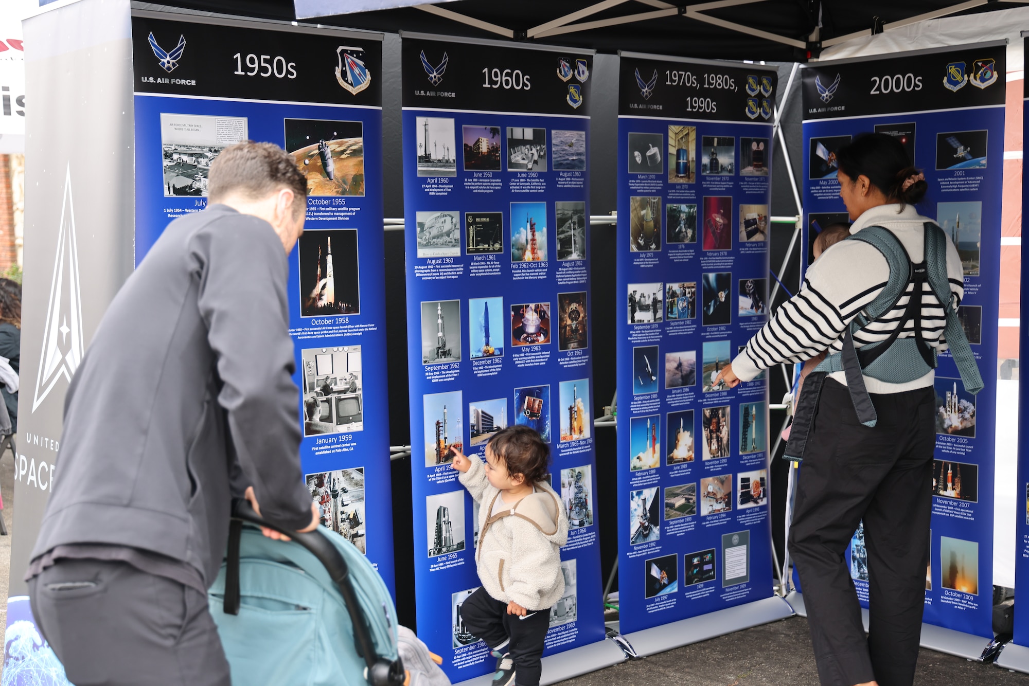 Community members gather around to view a timeline of the United States Space Force history at the Main Street Fair on Sept. 28,2024, in El Segundo, Calif. (U.S. Space Force photo by Edgar Nava).