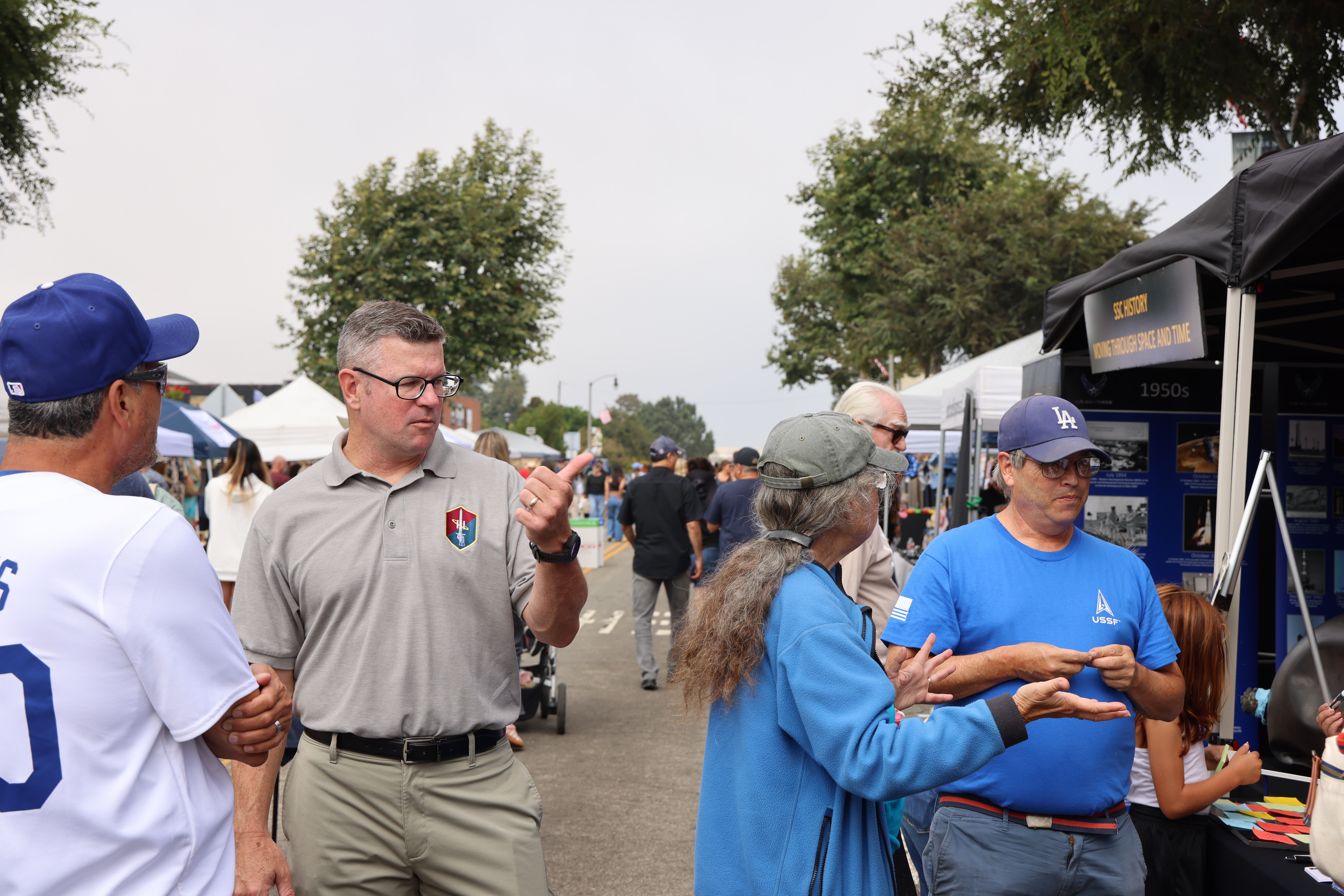 Col. Andrew Dermanoski, Commander, Space Base Delta 3, speaks with community members at the El Segundo Main Street Fair on Sept. 28, 2024, in El Segundo, Calif. The Main Street Fair is an annual event that celebrates vendors and local business of the El Segundo area. (U.S. Space Force photo by Edgar Nava).