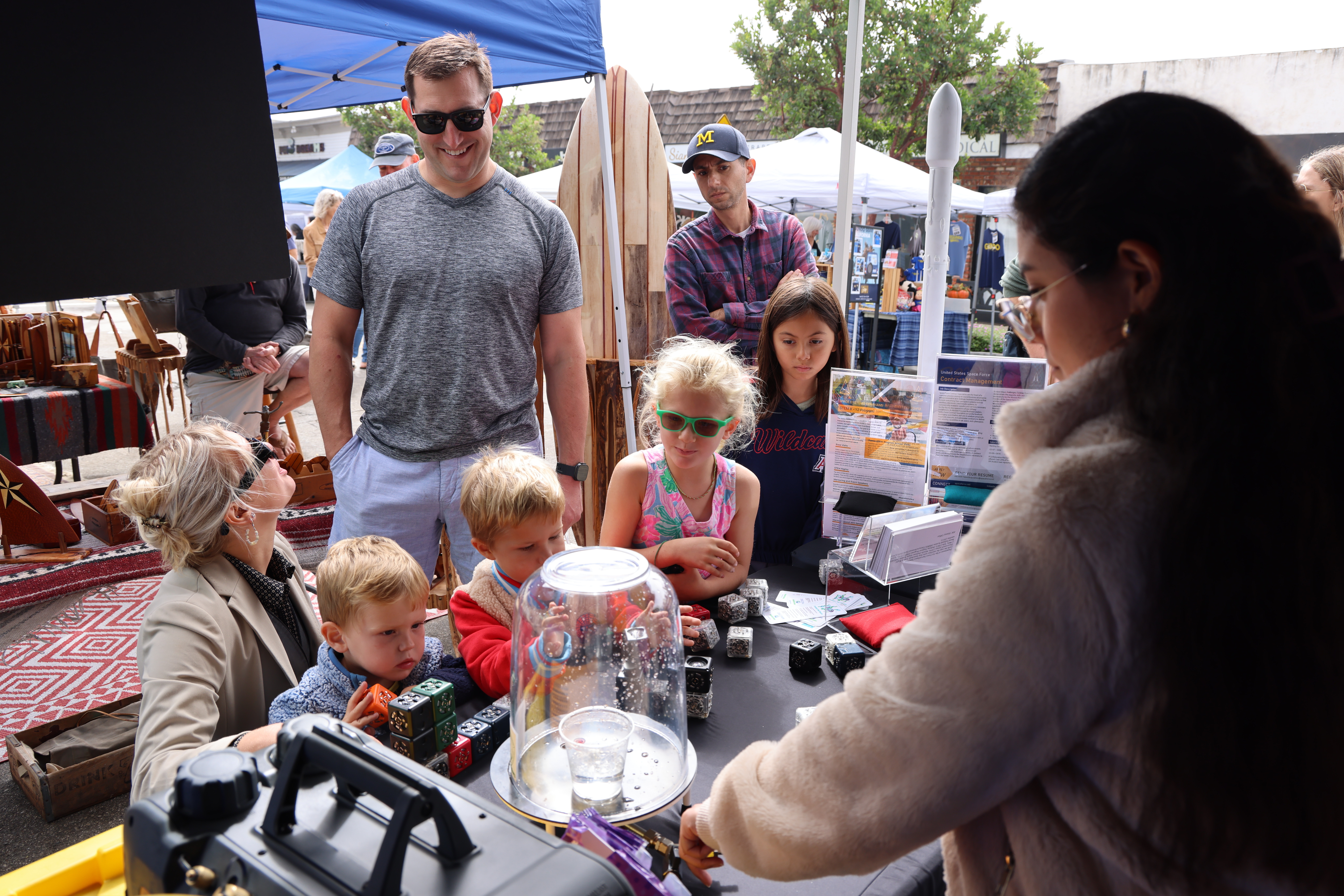 Families and their kids participate in STEM activities at the Main Street Fair on Sept. 28, 2024, in El Segundo, Calif. Activities included demonstrations of how a space vacuum chamber function and the opportunity to create their own robots with building cubes. (U.S. Space Force photo by Edgar Nava).