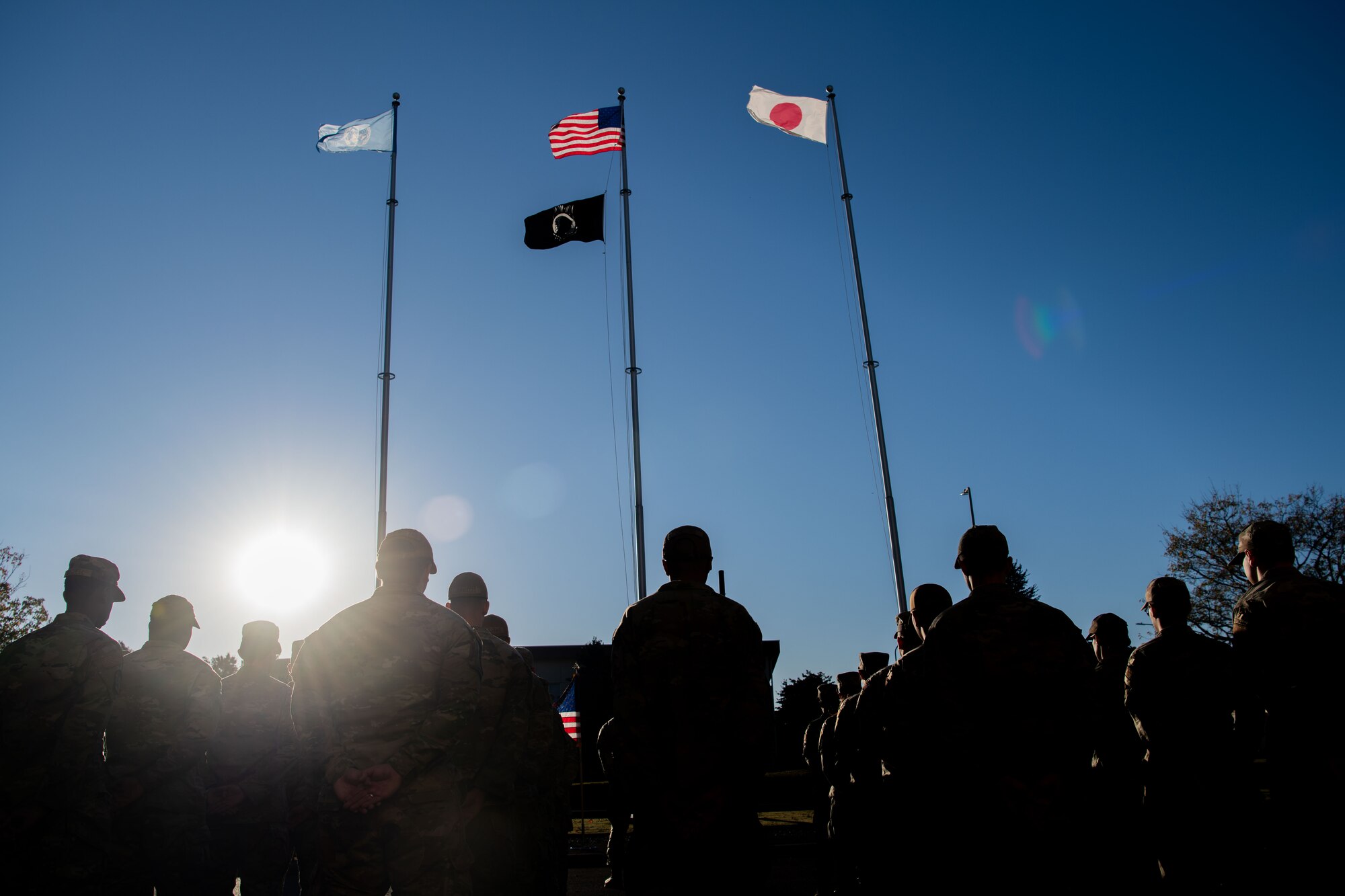 Airmen stand at parade rest in formation during a Veterans Day ceremony at Yokota