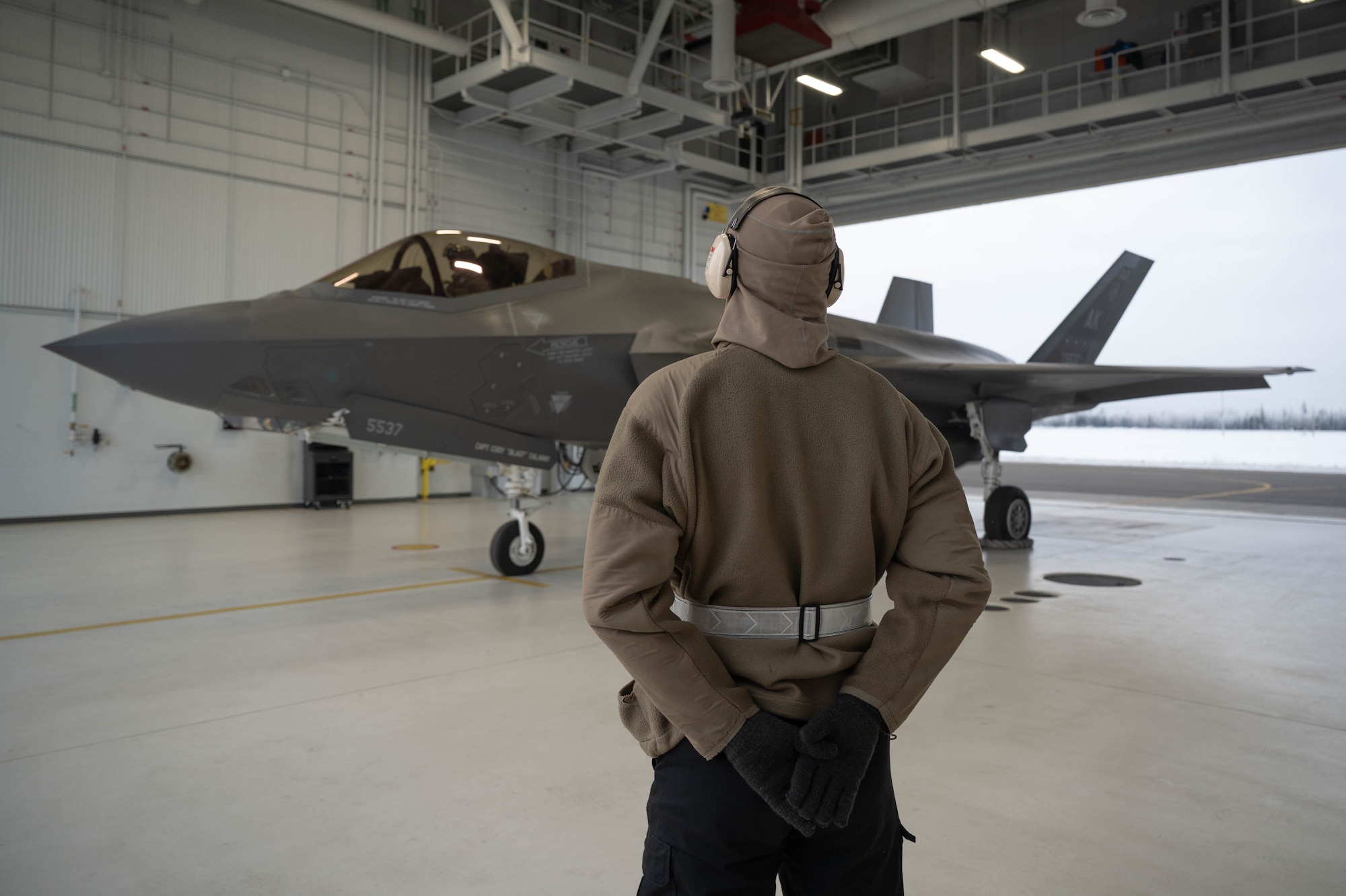 U.S. Air Force Senior Airman Dale Allen, 355th Fighter Generation Squadron crew chief, stands by before taxiing an F-35A lightning II onto the runway at Eielson Air Force Base, Alaska, Nov. 13, 2024.
