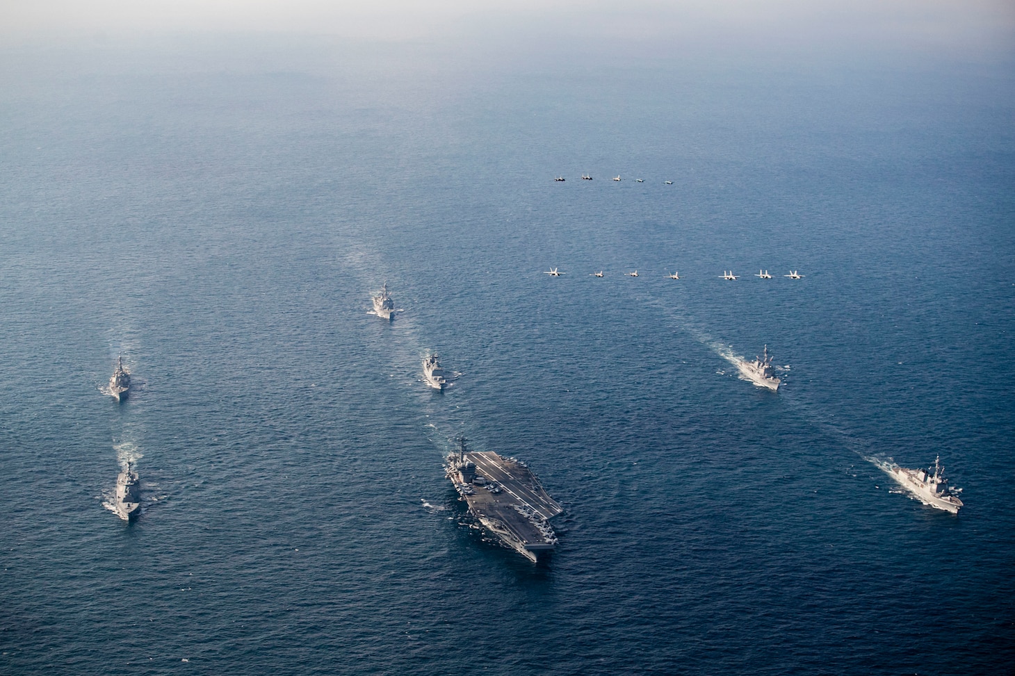 Nimitz-class aircraft carrier USS George Washington (CVN 73), Arleigh Burke-class guided-missile destroyers USS Higgins (DDG 76), USS McCampbell (DDG 85) and USS Dewey (DDG 105), Japan Maritime Self-Defense Force Maya-class guided-missile destroyer JS Haguro (DDH 180), Republic of Korea Navy Chungmugong Yi Sun-sin-class destroyer ROKS Chungmugong Yi Sun-sin (DDH-975), and Sejong the Great-class destroyer ROKS Seoae Ryu Seong-ryong (DDG 993) steam in formation as aircrafts assigned to Carrier Air Wing 5, U.S. Air Force, Japan Air Self-Defense Force, and Republic of Korea Air Force fly over the formation during Freedom Edge 24-2 in the East China Sea, Nov. 13, 2024. Freedom Edge demonstrates a new era of trilateral cooperation to ensure peace and stability in the Korean Peninsula and the Indo-Pacific. George Washington is 7th Fleet’s premier forward-deployed aircraft carrier, a long-standing symbol of the United States’ commitment to maintaining a free and open Indo-Pacific region, while operating alongside Allies and partners across the U.S. Navy’s largest numbered fleet. (U.S. Navy photo by Mass Communication Specialist Seaman Geoffrey L. Ottinger)