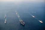 Nimitz-class aircraft carrier USS George Washington (CVN 73), Arleigh Burke-class guided-missile destroyers USS Higgins (DDG 76), USS McCampbell (DDG 85) and USS Dewey (DDG 105), Japan Maritime Self-Defense Force Maya-class guided-missile destroyer JS Haguro (DDH 180), Republic of Korea Navy Chungmugong Yi Sun-sin-class destroyer ROKS Chungmugong Yi Sun-sin (DDH-975), and Sejong the Great-class destroyer ROKS Seoae Ryu Seong-ryong (DDG 993) steam in formation as aircrafts assigned to Carrier Air Wing 5, U.S. Air Force, Japan Air Self-Defense Force, and Republic of Korea Air Force fly over the formation during Freedom Edge 24-2 in the East China Sea, Nov. 13, 2024. Freedom Edge demonstrates a new era of trilateral cooperation to ensure peace and stability in the Korean Peninsula and the Indo-Pacific. George Washington is 7th Fleet’s premier forward-deployed aircraft carrier, a long-standing symbol of the United States’ commitment to maintaining a free and open Indo-Pacific region, while operating alongside Allies and partners across the U.S. Navy’s largest numbered fleet. (U.S. Navy photo by Mass Communication Specialist Seaman Geoffrey L. Ottinger)