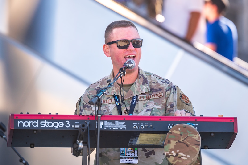 U.S. Air Force Tech. Sgt. Aaron Trasatt, Max Impact ensemble member, plays a keyboard and sings during a performance as a part of the NASCAR Championship pre-race events November 10, 2024, at Phoenix Raceway in Avondale, Arizona.