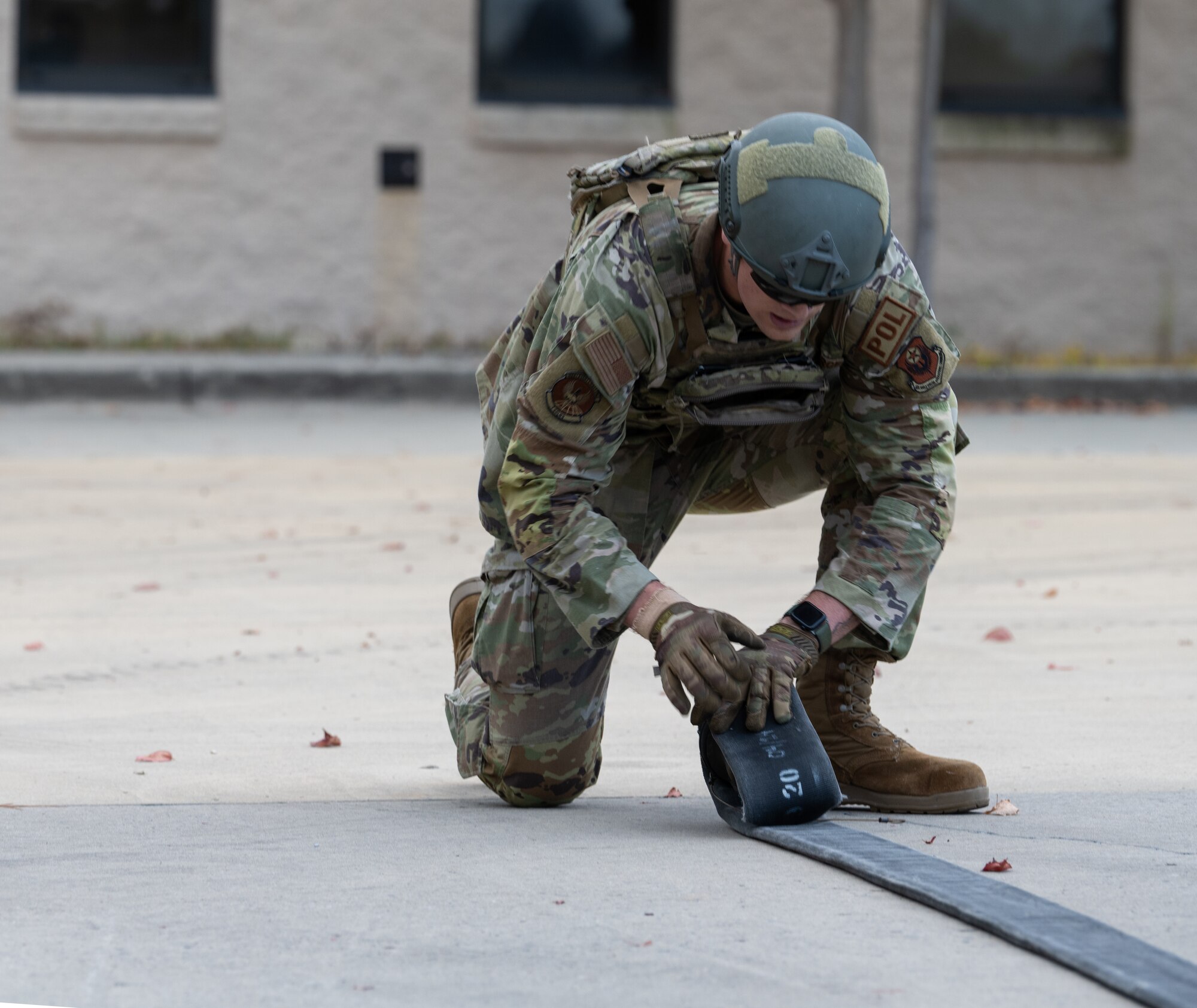 An Air Commando from the 1st Special Operations Logistics Readiness Squadron rolls up a refueling hose during a Forward Area Refueling Point tryout at Hurlburt Field, Florida, Oct. 31, 2024.