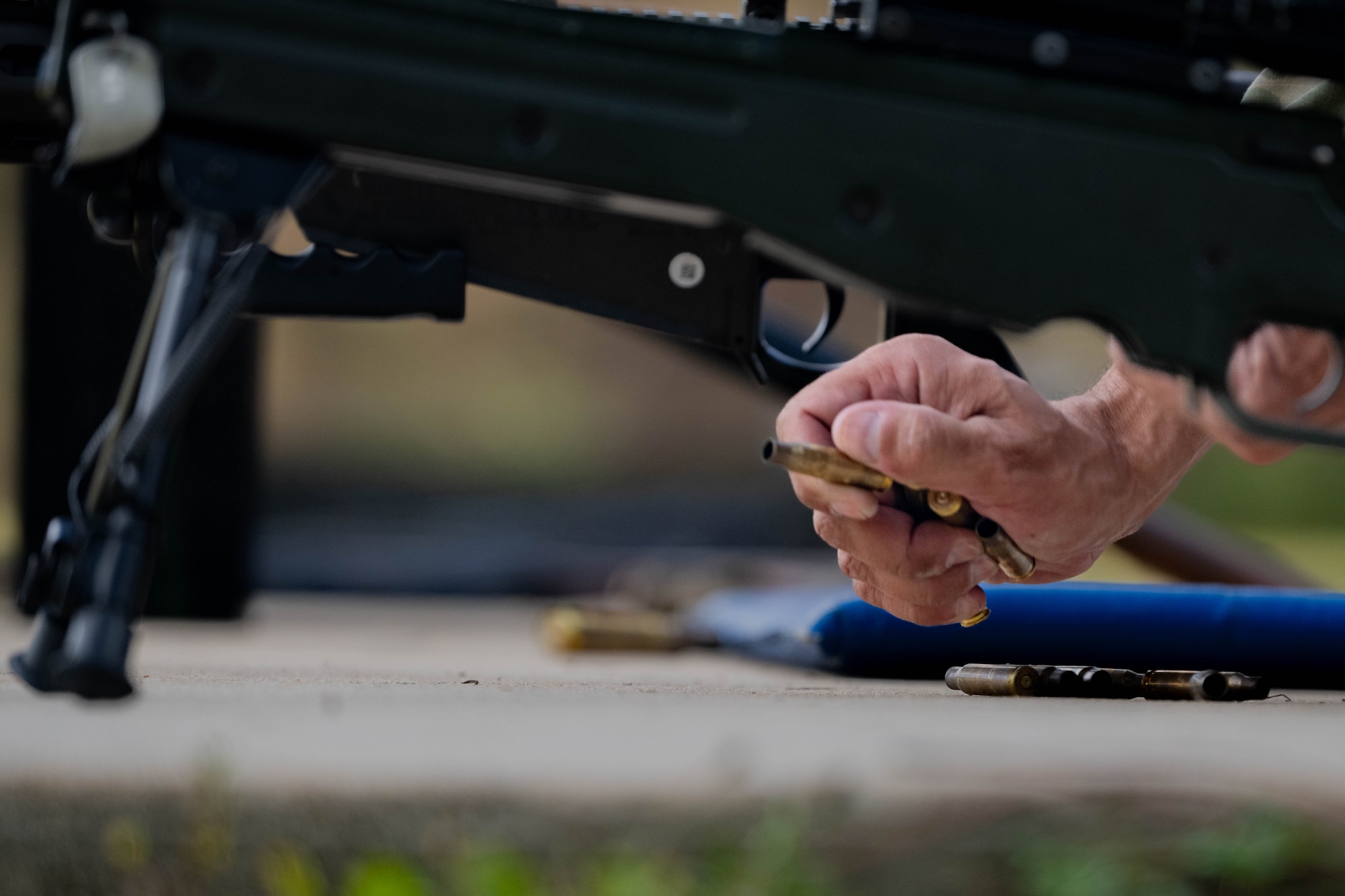 A U.S. Air Commando gathers weapon casings during the Service Member of the Year competition at Hurlburt Field, Florida, Oct. 30, 2024.