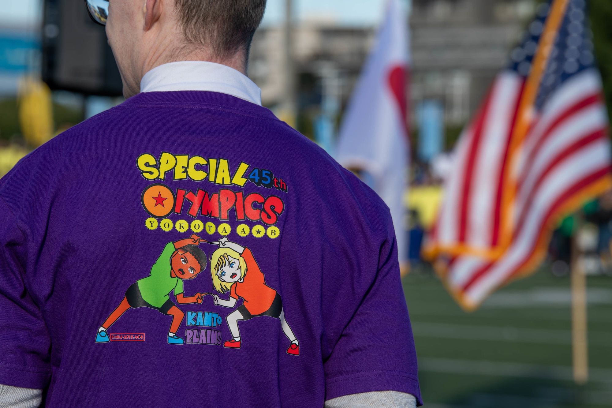 A volunteer wears the official 45th Kanto Plains Special Olympics t-shirt.