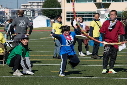 Athletes participate in the disc throwing competition.