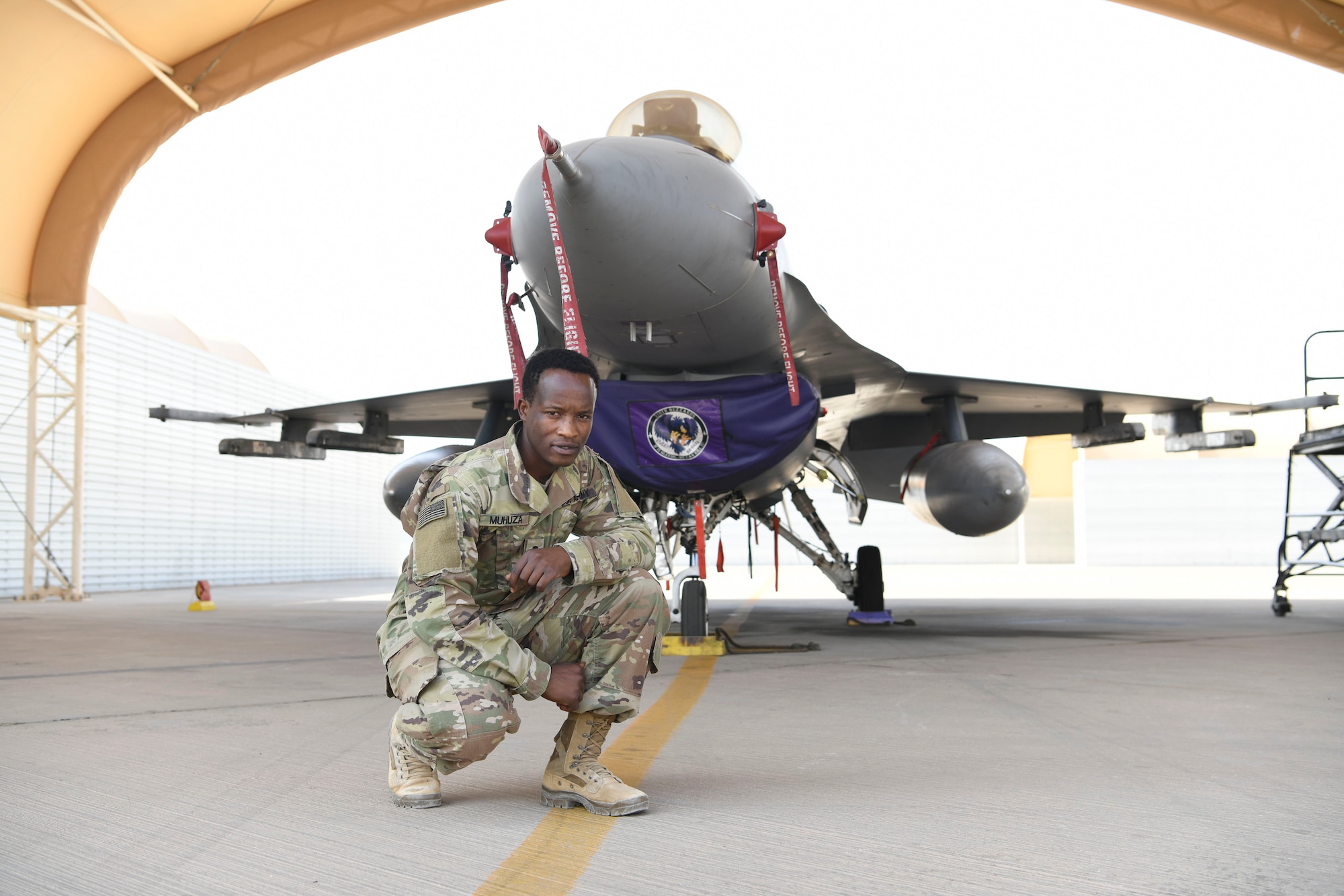 U.S. Army Sgt. Aimable Muhuza, 401st Medical Logistics Company medical logistics manager, poses in front of an F-16 Fighting Falcon before his promotion ceremony in the U.S. Central Command area of responsibility, Oct. 22, 2024.