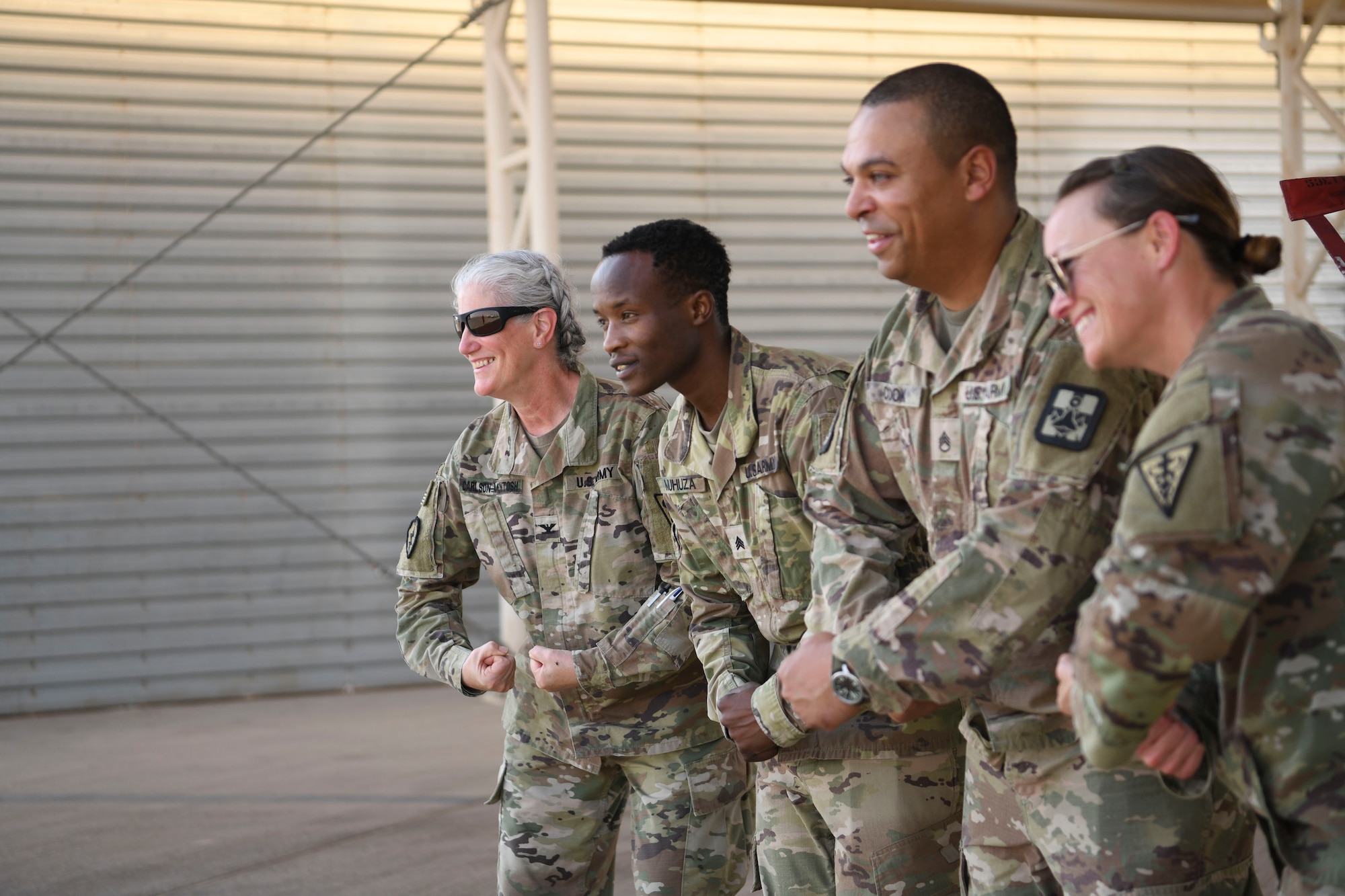 U.S. Army Sgt. Aimable Muhuza, 401st Medical Logistics Company medical logistics manager, poses in front of an F-16 Fighting Falcon with fellow soldiers following his promotion ceremony in the U.S. Central Command area of responsibility, Oct. 22, 2024.