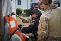 U.S. service member with Maritime Security Response Team East, right, and U.S. Marine Corps Staff Sgt. Christopher Nabholz, furthest in the rear, 2336 Explosive Ordnance Disposal (EOD) Technician, 8th Engineer Support Battalion, 2d Marine Logistics Group, and engage in mechanical breaching training with U.S. partner forces as part of exercise Phoenix Express 2024 in Bizerte, Tunisia, Nov. 6, 2024.