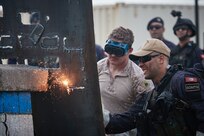 U.S. Marine Corps Sgt. Andrew Donahue, left, 2336 Explosive Ordnance Disposal (EOD) Technician, 8th Engineer Support Battalion, 2d Marine Logistics Group, conducts exothermic breaching training with a member of the Tunisian Naval Forces as part of exercise Phoenix Express 2024 in Bizerte, Tunisia, Nov. 6, 2024.