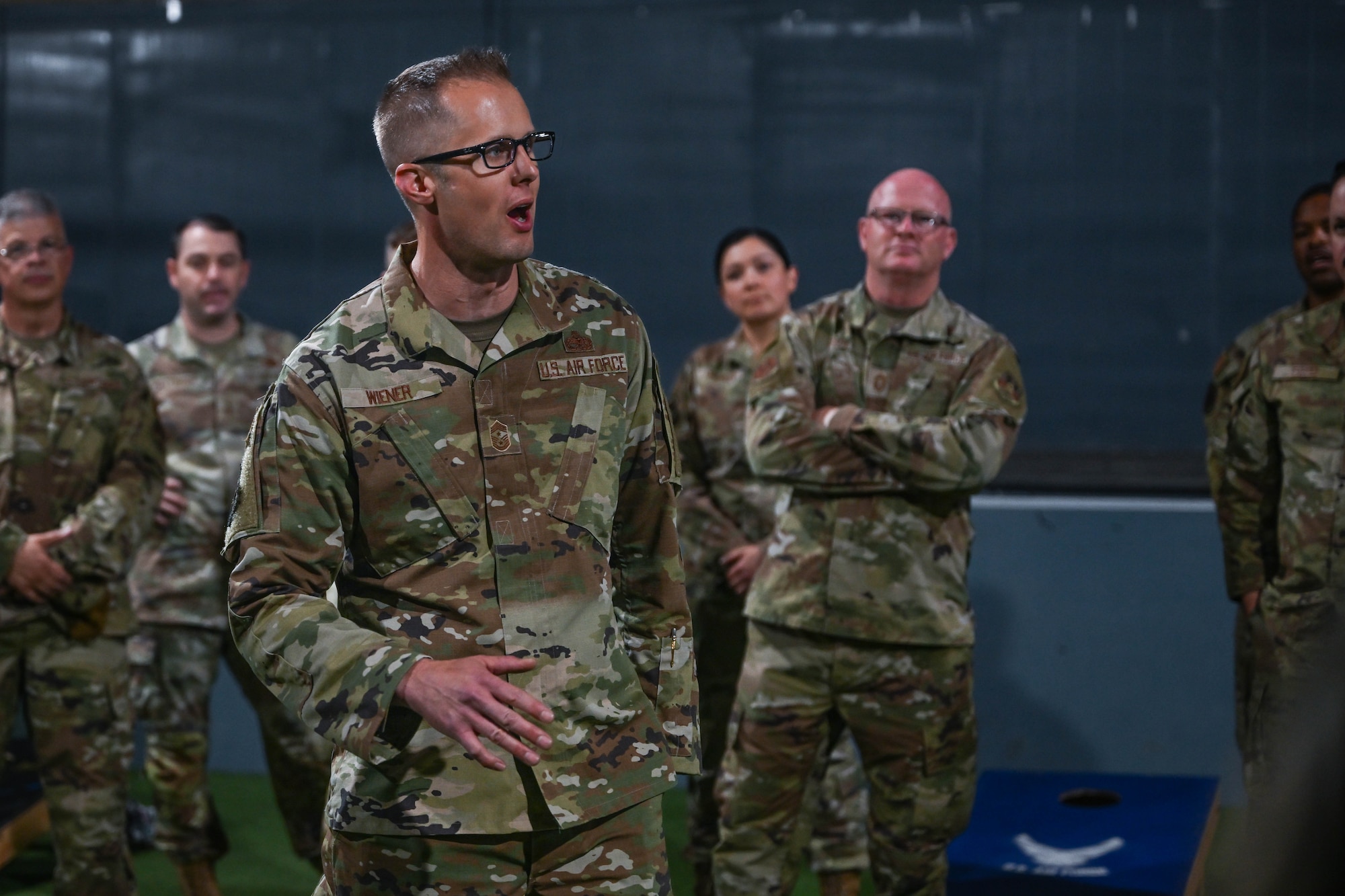 A military member speaks to a group of people during a visit to the installation.