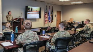 Master Sgt. Michelle Caswell, 445th Force Support Squadron Military & Family Readiness Center readiness NCO in charge, briefs new members of the 445th Airlift Wing about M&FRC’s office and services provided during a newcomer’s meeting at Wright-Patterson Air Force Base, Ohio, Oct. 5, 2024. The newcomers’ briefing is a mandatory program for incoming members, providing a comprehensive overview of services and operations at the wing. (U.S. Air Force photo/Senior Airman Angela Jackson)