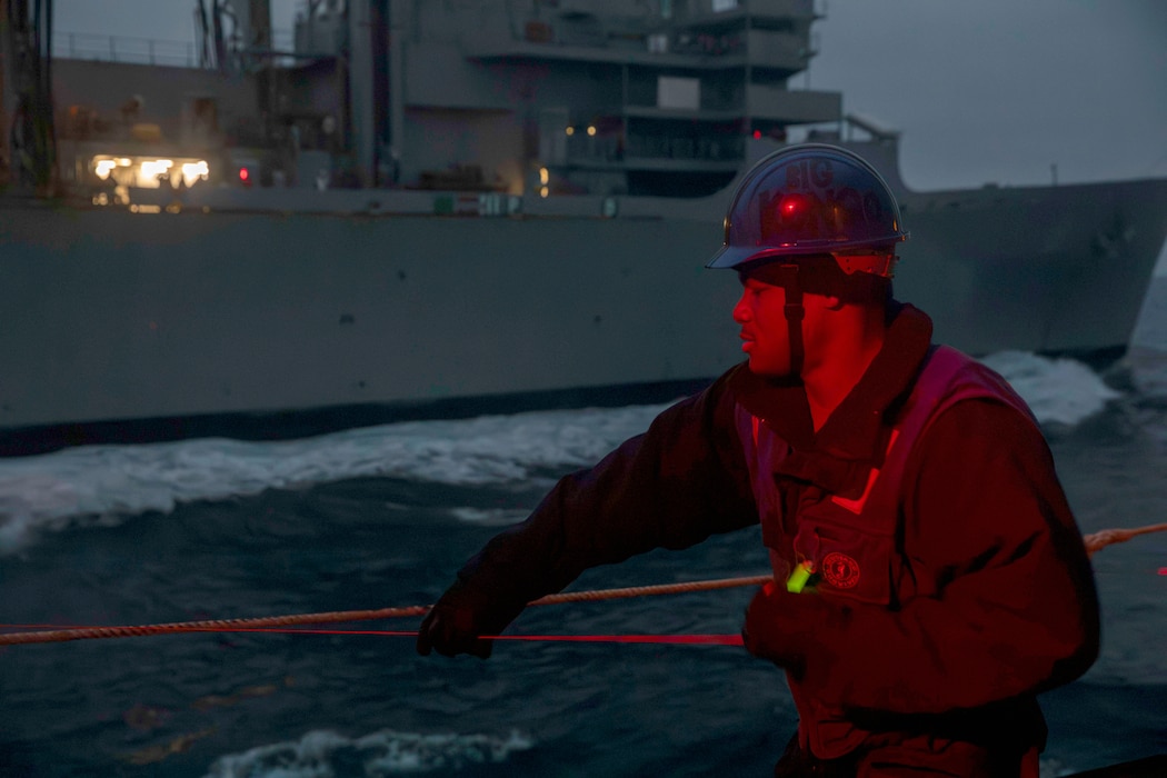 BMSN Exauce Mukongo heaves a shot line aboard USS Gettysburg (CG 64) during a replenishment with USNS Arctic (T-AOE 8) in the North Sea.