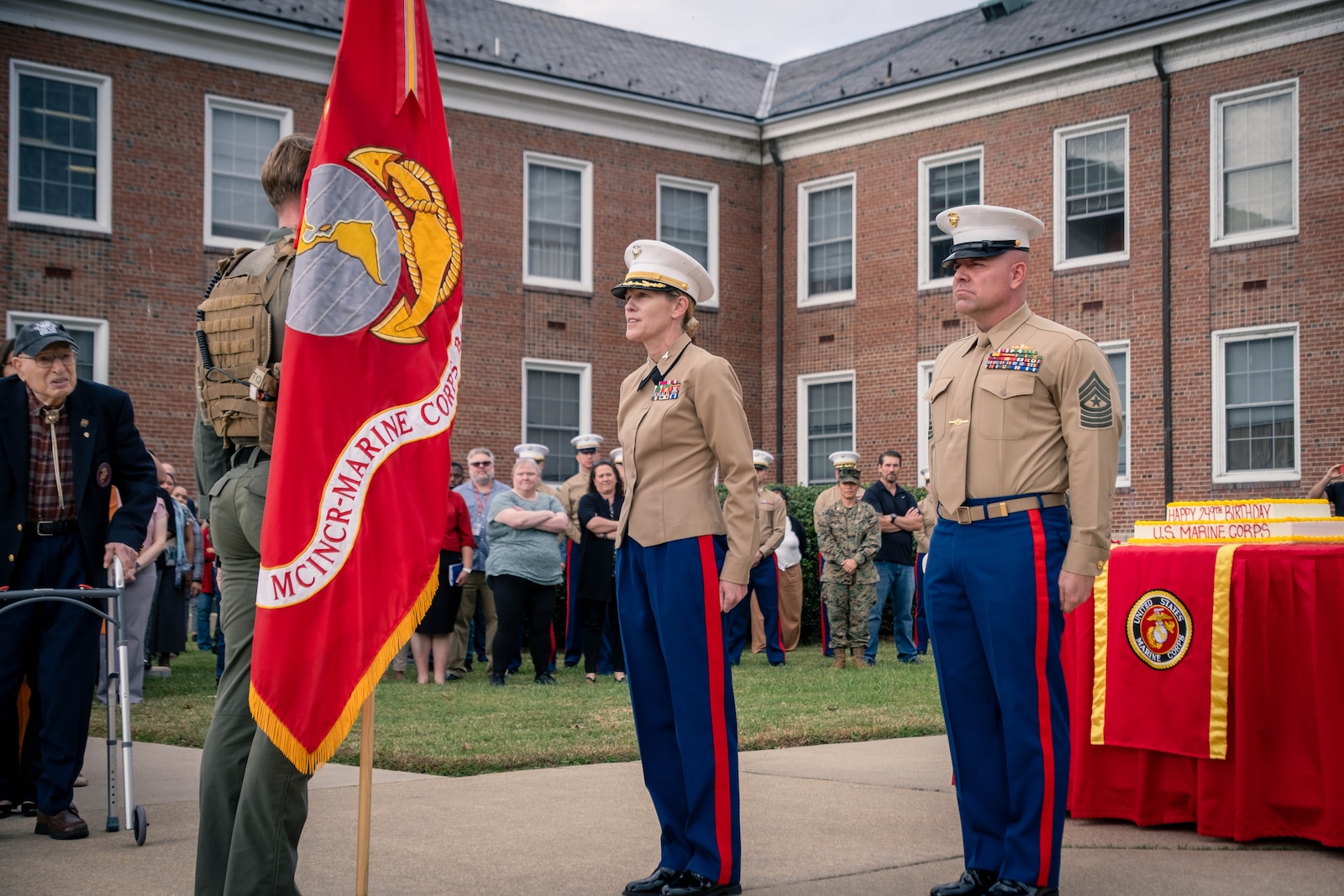 U.S. Marine Corps Col. Jenny Colegate, base commander of Marine Corps Base Quantico, right, receives the Marine Corps flag during the Marine Corps cake cutting ceremony in honor of the 249th Marine Corps birthday on MCBQ, Virginia, Nov. 7, 2024. The annual celebration is a long-standing tradition which celebrates the establishment of the United States Marine Corps on Nov. 10, 1775 and honors the service and sacrifice of all Marines, past and present. (U.S. Marine Corps photo by Lance Cpl. Joaquin Dela Torre)