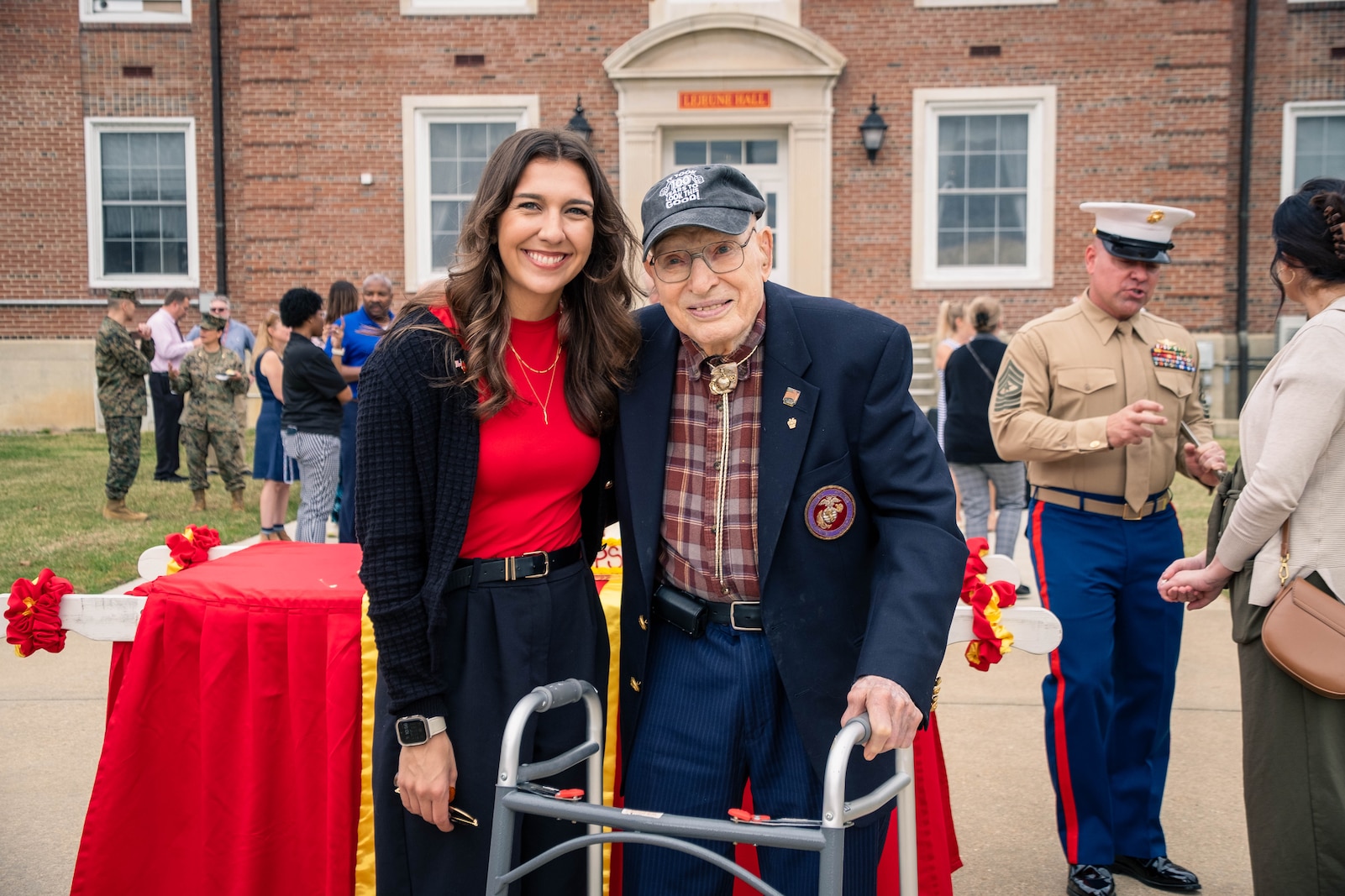 U.S. Marine Corps veteran Sgt. Carley Vedro, the youngest Marine in attendance, left, and retired U.S. Marine Corps Col. Frank Harris III, the oldest Marine in attendance at 100 years old, pose for a photo during the Marine Corps cake cutting ceremony in honor of the 249th Marine Corps birthday on Marine Corps Base Quantico, Virginia, Nov. 7, 2024. The annual celebration is a long-standing tradition which celebrates the establishment of the United States Marine Corps on Nov. 10, 1775 and honors the service and sacrifice of all Marines, past and present. (U.S. Marine Corps photo by Lance Cpl. Joaquin Dela Torre)