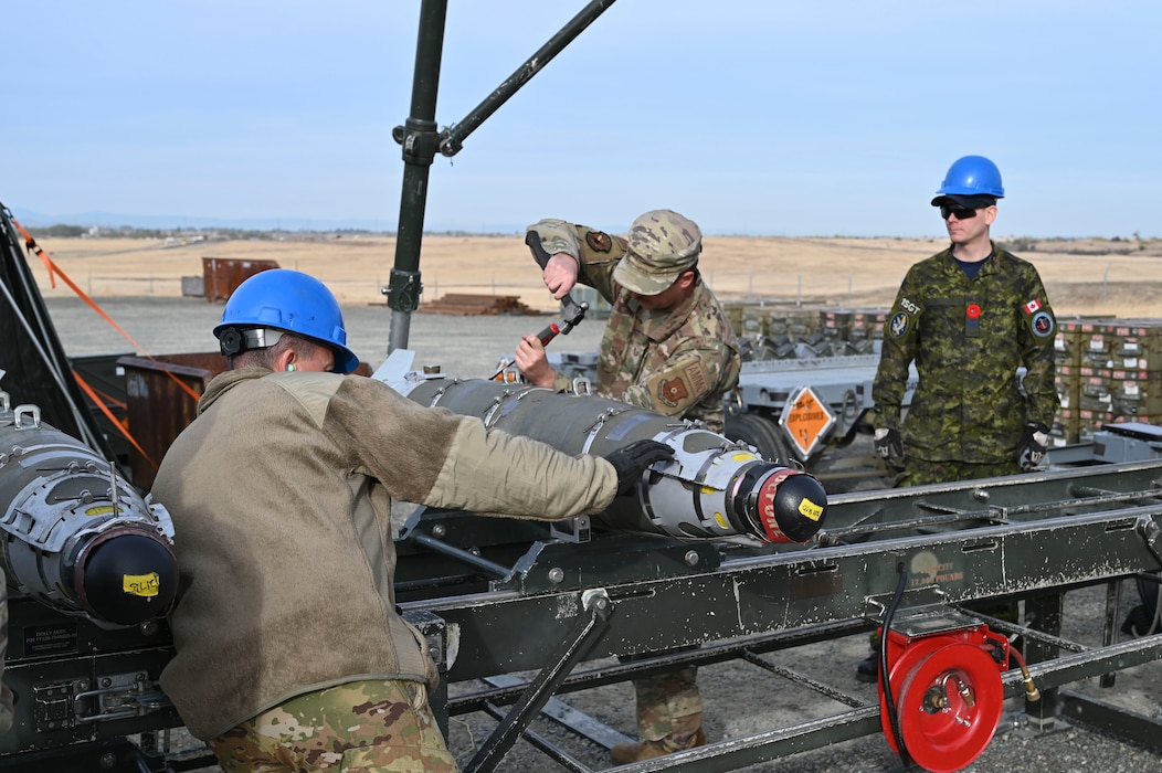 U.S. Air Force Airmen, and Sgt. Kristjan Lindvere of the Royal Canadian Air Force, man the munitions assembly conveyor during hands-on training with the Air Force Combat Ammunition Center (AFCOMAC) at Beale Air Force Base, California, Nov. 5, 2024.