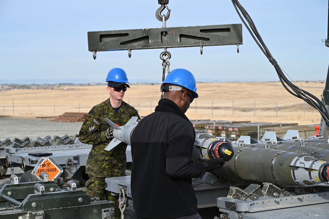 U.S. Air Force Airmen, and Sgt. Kristjan Lindvere of the Canadian Air Force, man the munitions assembly conveyor during hands on training with the Air Force Combat Ammunition Course (AFCOMAC) at Beale Air Force Base, California, Nov. 5, 2024.