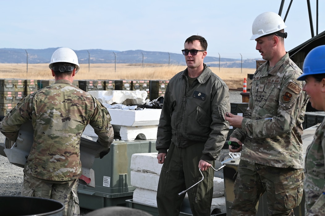 U.S. Marine Corp Chief Warrant Officer Tyler Bluder and U.S. Air Force Airmen unload tail sections during the Iron Flag hands-on exercise with the Air Force Combat Ammunition Center (AFCOMAC) at Beale Air Force Base, California, Nov. 5, 2024.