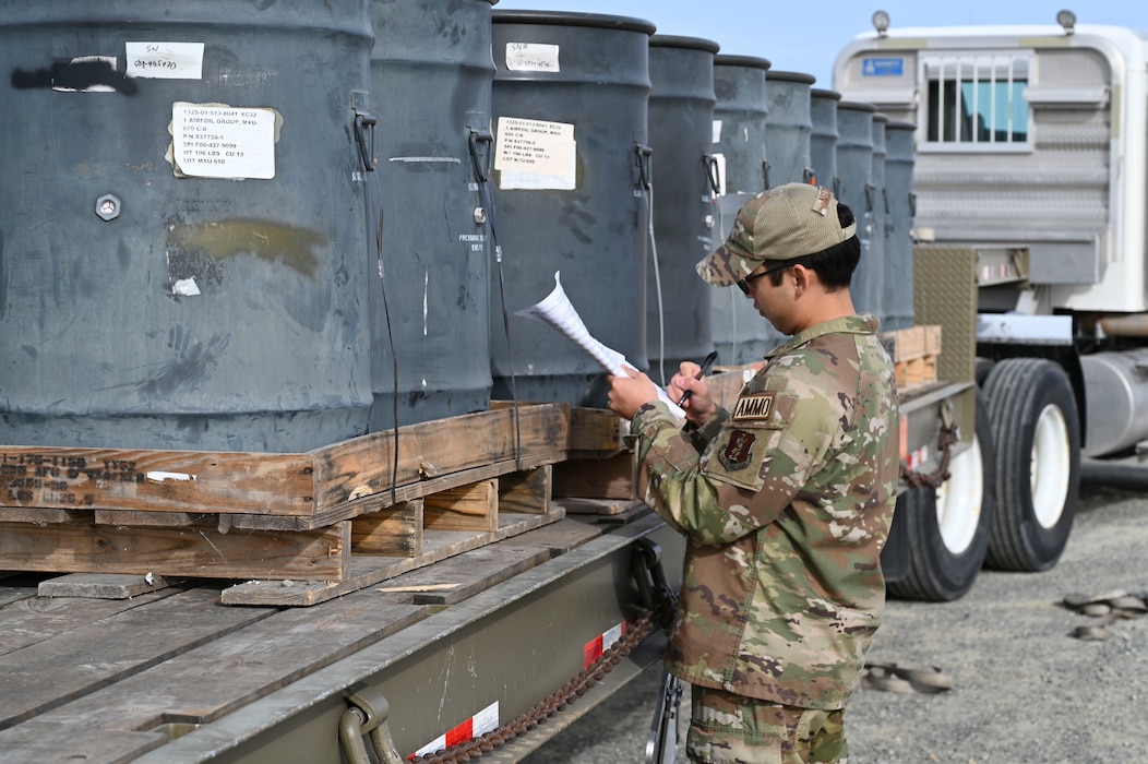 U.S. Air Force Staff Sgt. Victor Nyguen inventories tail assemblies in containers as they arrive on the pad during training with the Air Force Combat Ammunition Center (AFCOMAC).