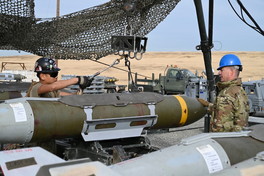 U.S. Air Force Airmen attach completed munitions on the munition assembly conveyor to a hoist during the Air Force Combat Ammunition Center’s course on Beale Air Force Base, California, Nov. 5, 2024.