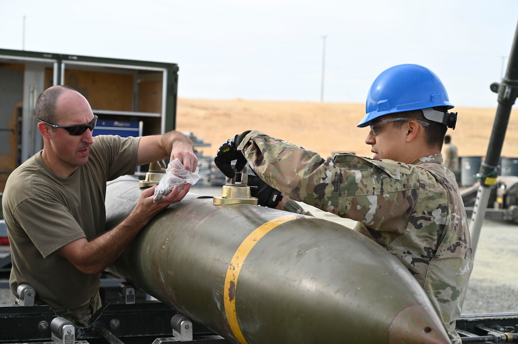 U.S. Air Force Airmen install fuses into munitions on the munition assembly conveyor during the Air Force Combat Ammunition Center’s Iron Flag hands-on exercise on Beale Air Force Base, California, Nov. 5, 2024.