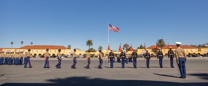 U.S. Marine Corps drill instructors and guides with Hotel Company, 2nd Recruit Training Battalion, march in formation prior to returning the guidons during a graduation ceremony at Marine Corps Recruit Depot San Diego, California, Nov. 8, 2024. This ceremony marked the end of a 13-week transformation that included training in drill, marksmanship, basic combat skills, and Marine Corps customs and traditions. (U.S. Marine Corps photo by Lance Cpl. Janell B. Alvarez)