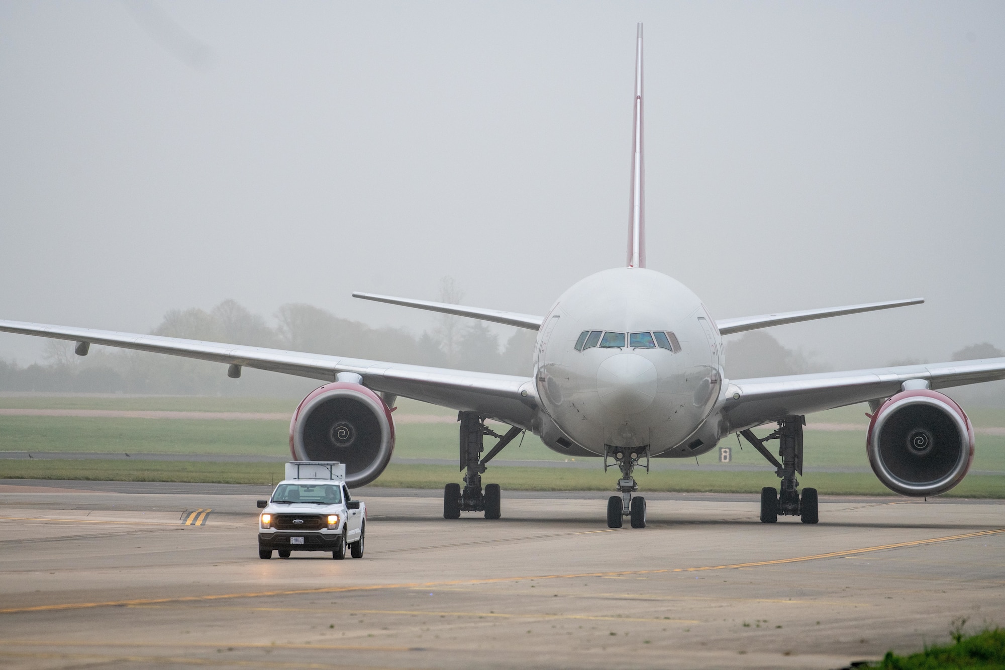An Omni Air International 777 aircraft taxis down the flightline