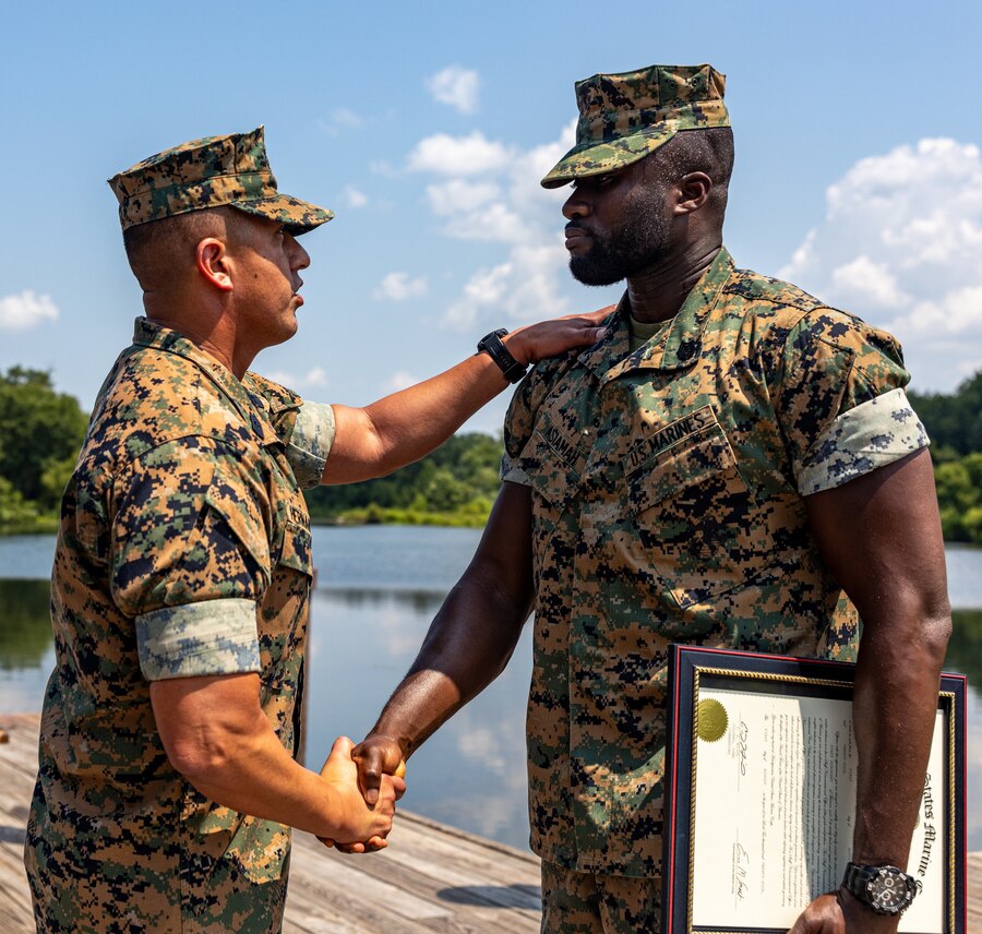 U.S. Marine Corps Sgt. Maj. Sergio Hernandez, Sergeant Major of Recruiting Station Baltimore, left, congratulates Sgt. Derrick Asiamah, a recruiter with Recruiting Sub-Station Columbia on his promotion to Staff Sergeant, Columbia, Maryland, August 1, 2024. Promotion to Staff Sergeant is a crucial stepping stone demonstrating a Marine's commitment, dedication, and mastery of technical skills, signifying their value to the unit. (U.S. Marine Corps photo by Sgt. Jonathan L. Gonzalez)