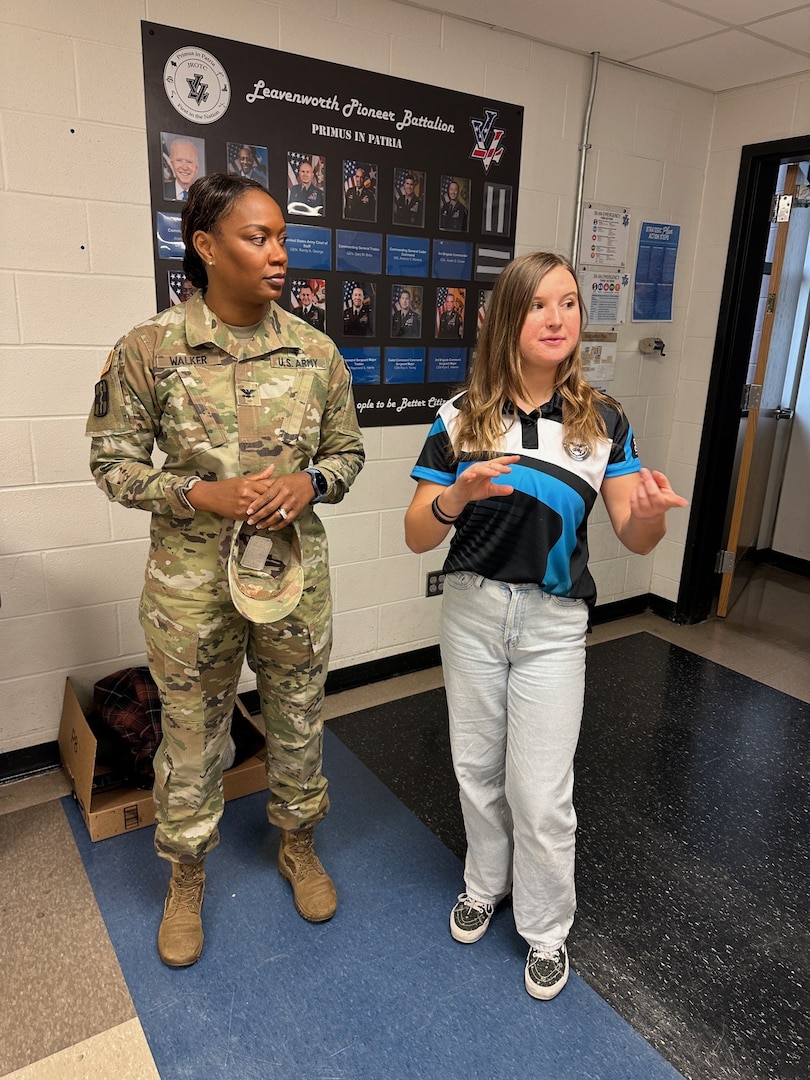 MTF Commander and high school student standing together