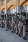 New U.S. Marine Corps recruits with Lima Company, 3rd Recruit Training Battalion, walk in formation to the squad bays prior to meeting their drill instructors as part of a pick-up event at Marine Corps Recruit Depot San Diego, California, Oct. 25, 2024. Pick-up day signifies the first official day of training in which recruits will meet their drill instructor team for the first time, prepare their gear and squad bay, and expectations are set for the remainder of their time in recruit training. (U.S. Marine Corps photo by Cpl. Alexandra M. Earl)